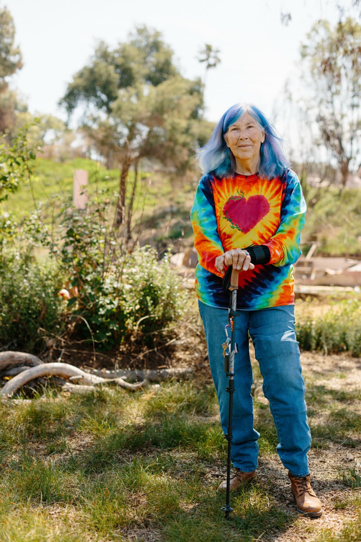 Leigh Adams stands in a garden.
