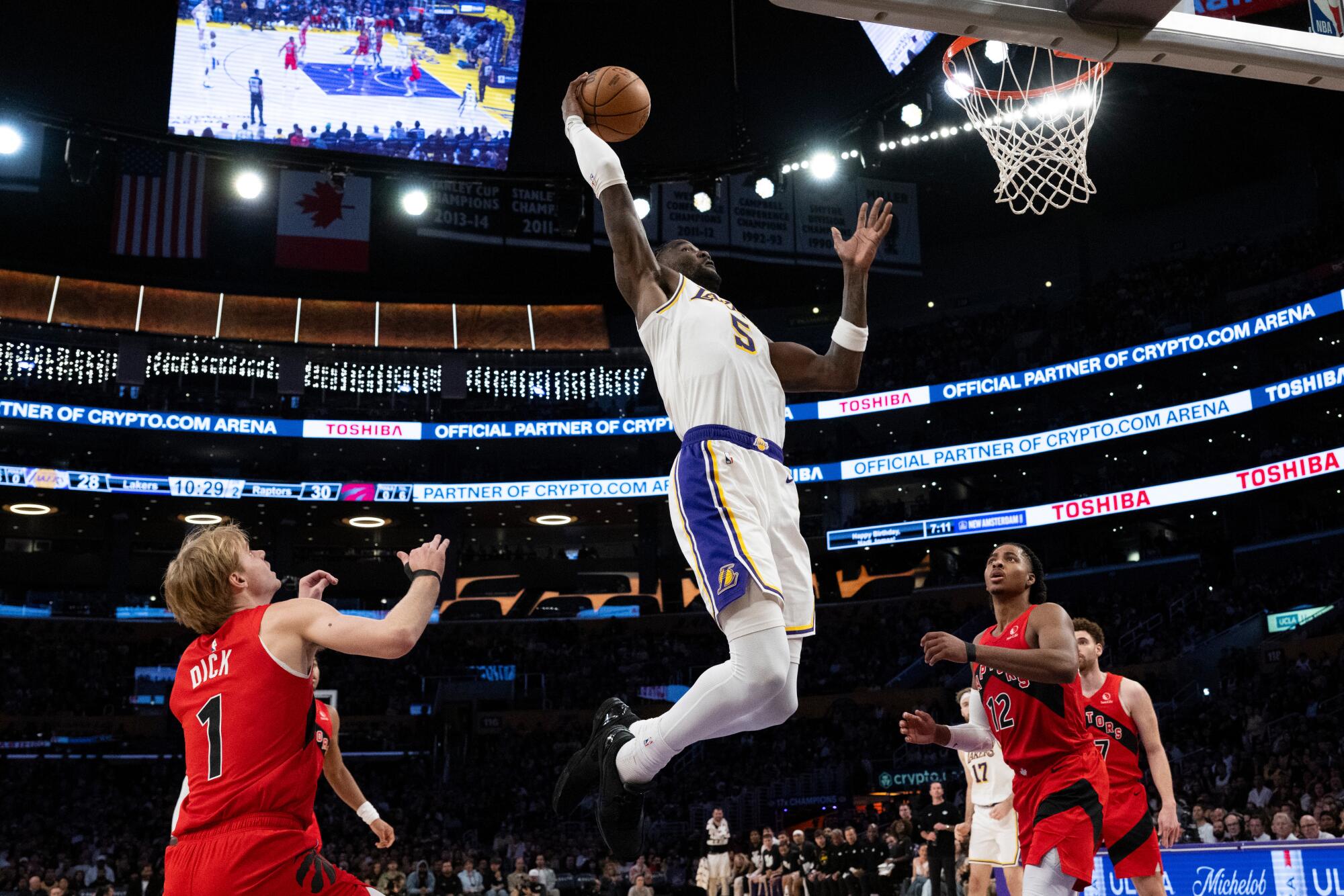 Lakers center Deandre Ayton (center) elevates for a dunk against the Raptors.