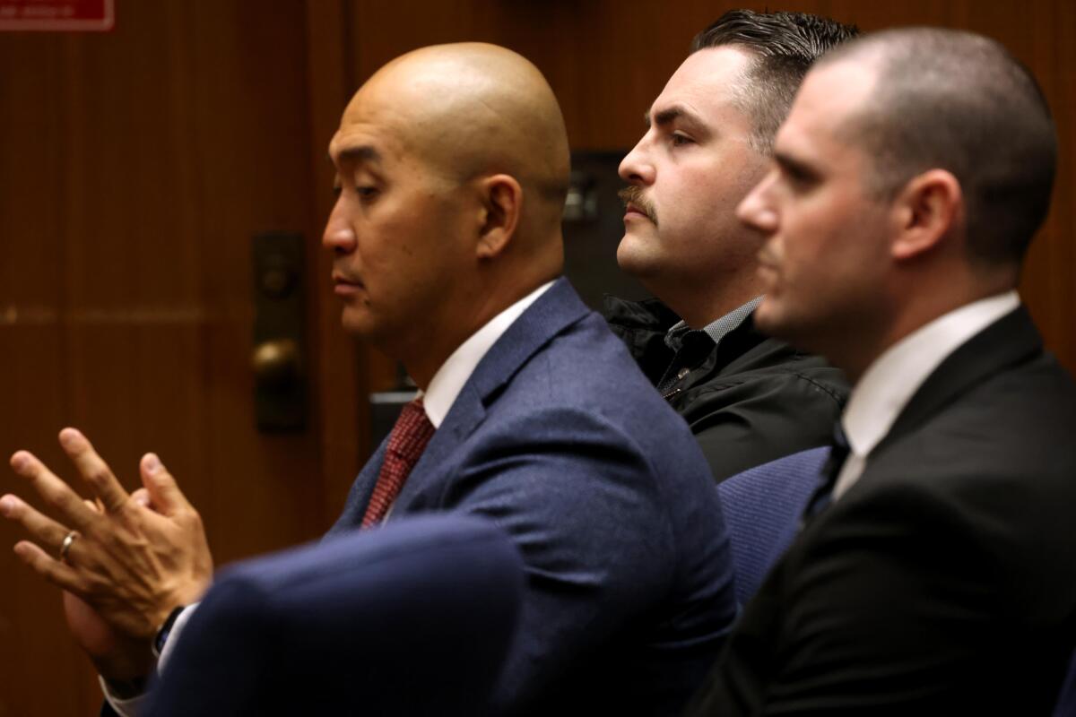 Former Torrance Police Officers Cody Weldin, center, and Christopher Tomsic, right, are seen in court.