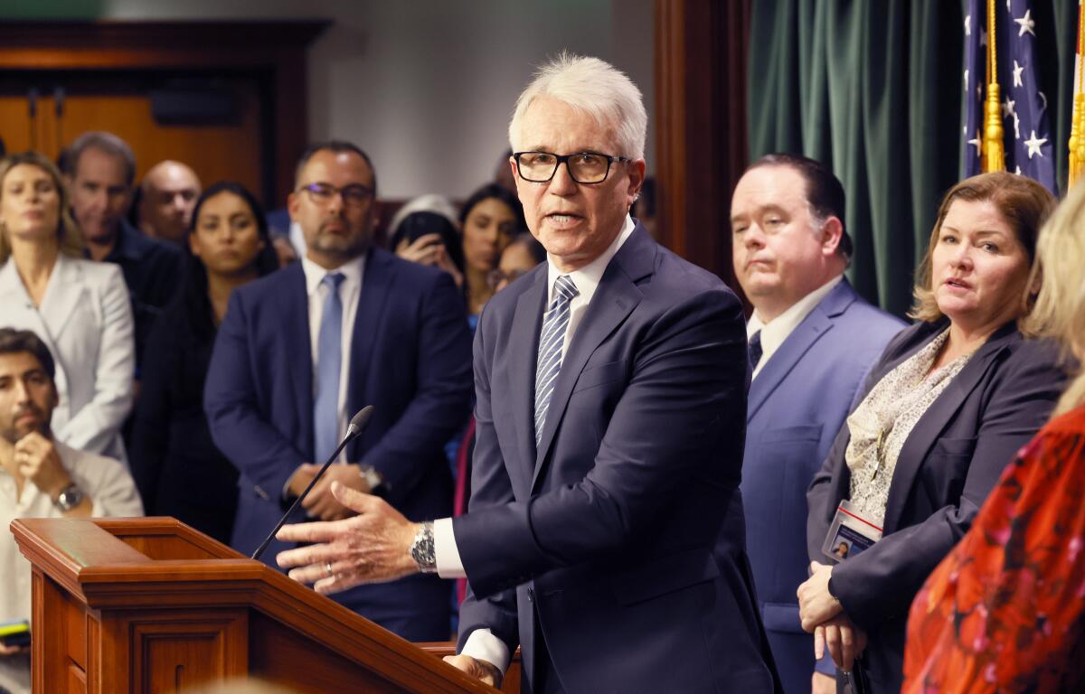 Flanked by family and staff, Los Angeles County Dist. Atty. George Gascón speaks.