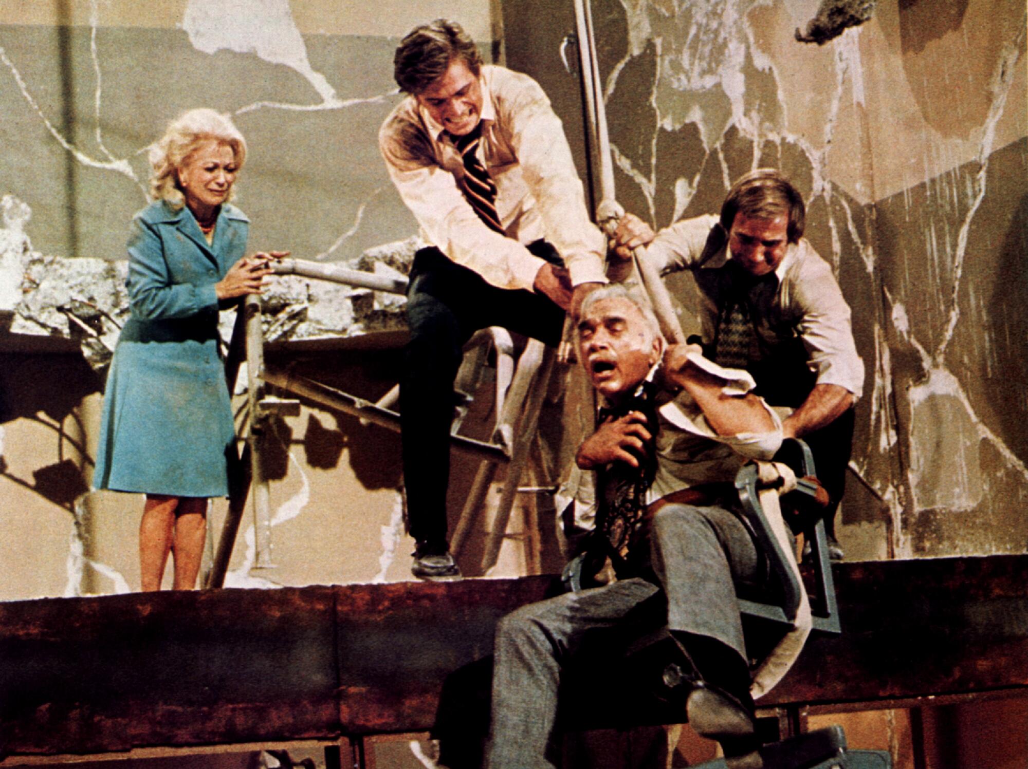 People in a damaged building hold onto a falling man.