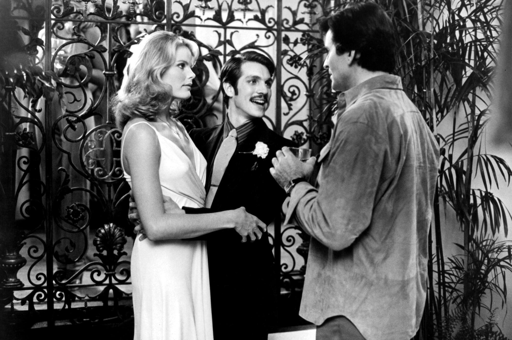 A blond woman is introduced to an interested man.