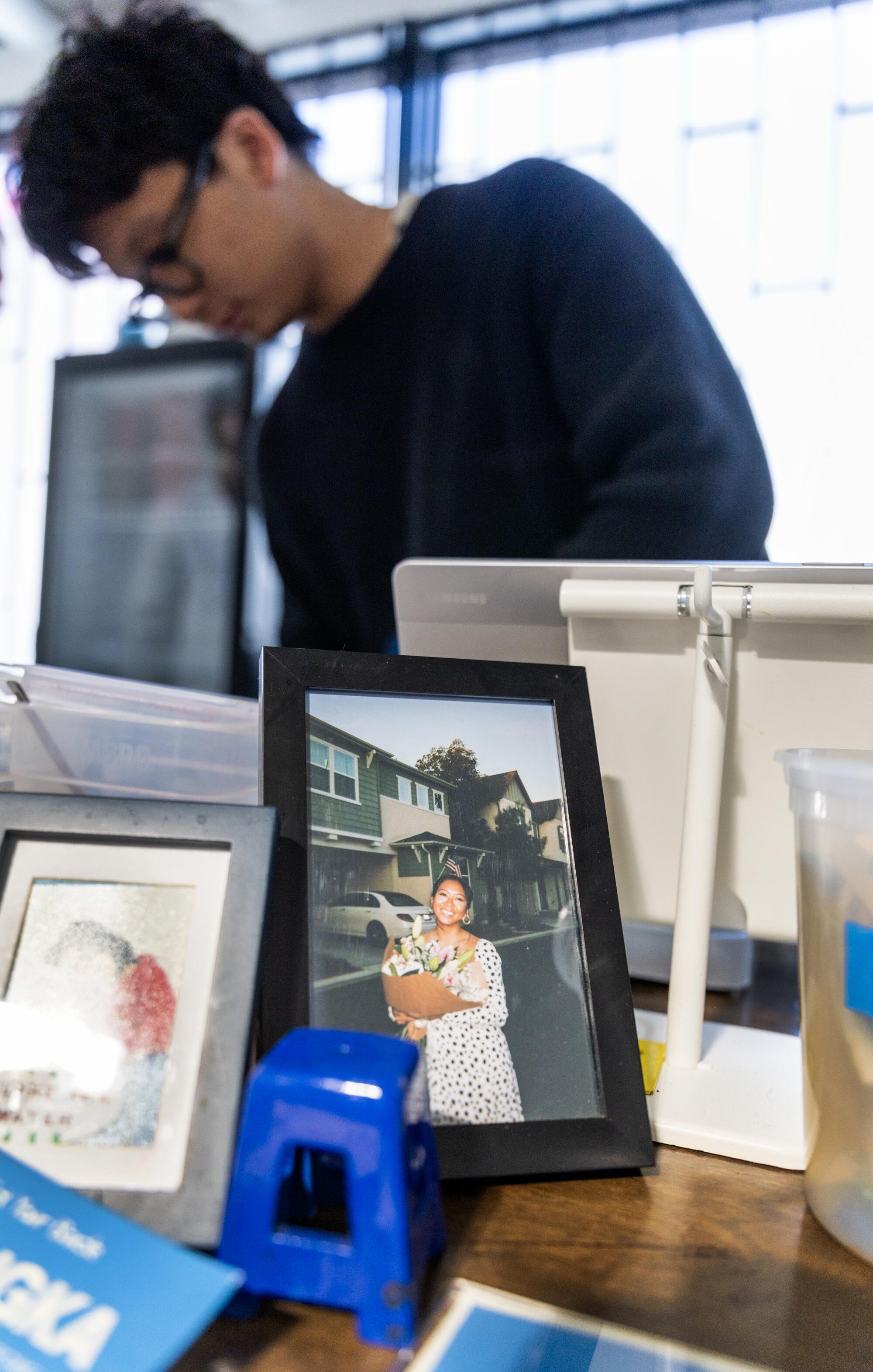 A framed photo of Reinne Lim in Reinne's Place coffee shop in Long Beach.
