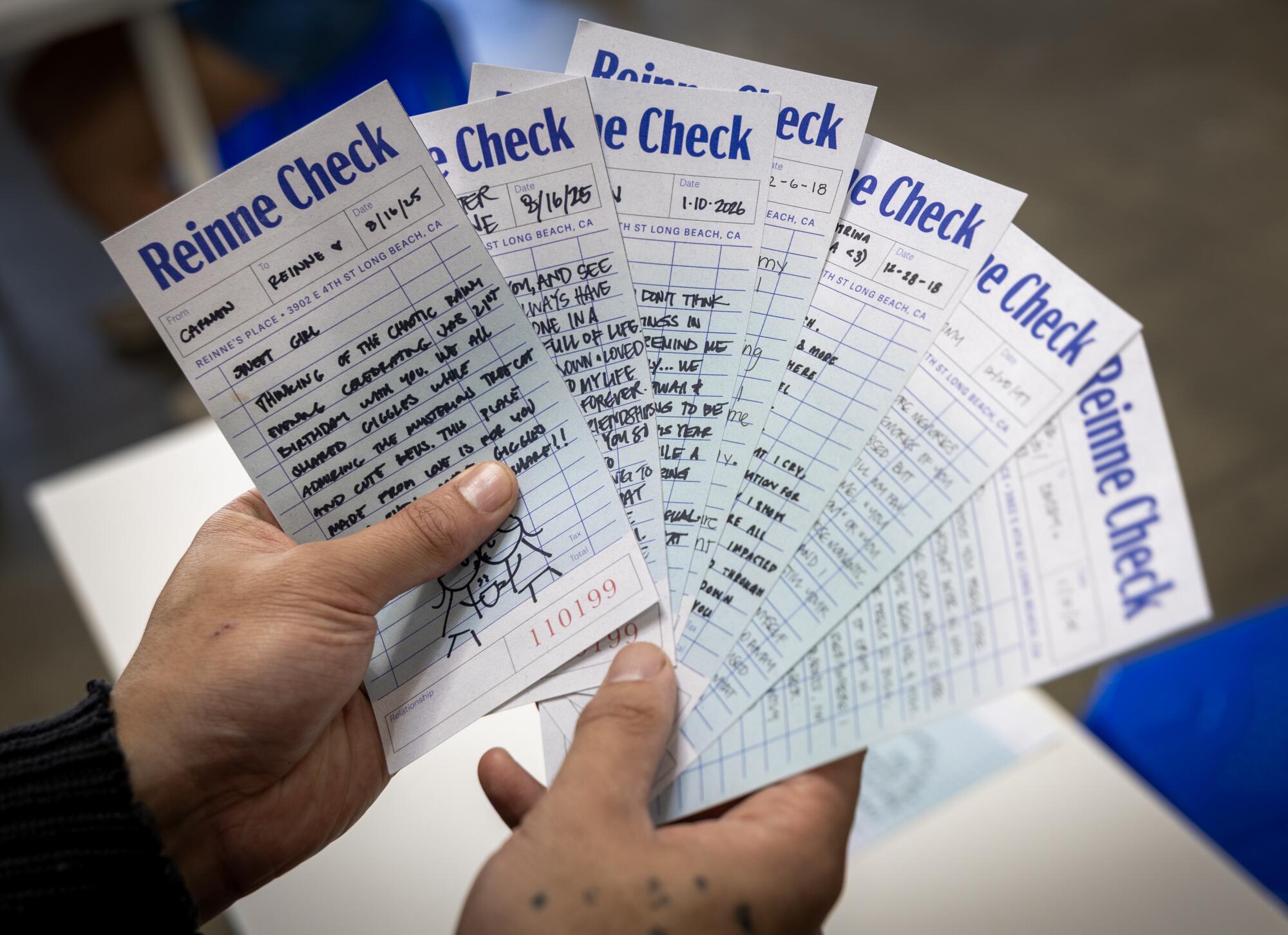 A detail of a bunch of reinne checks being held.