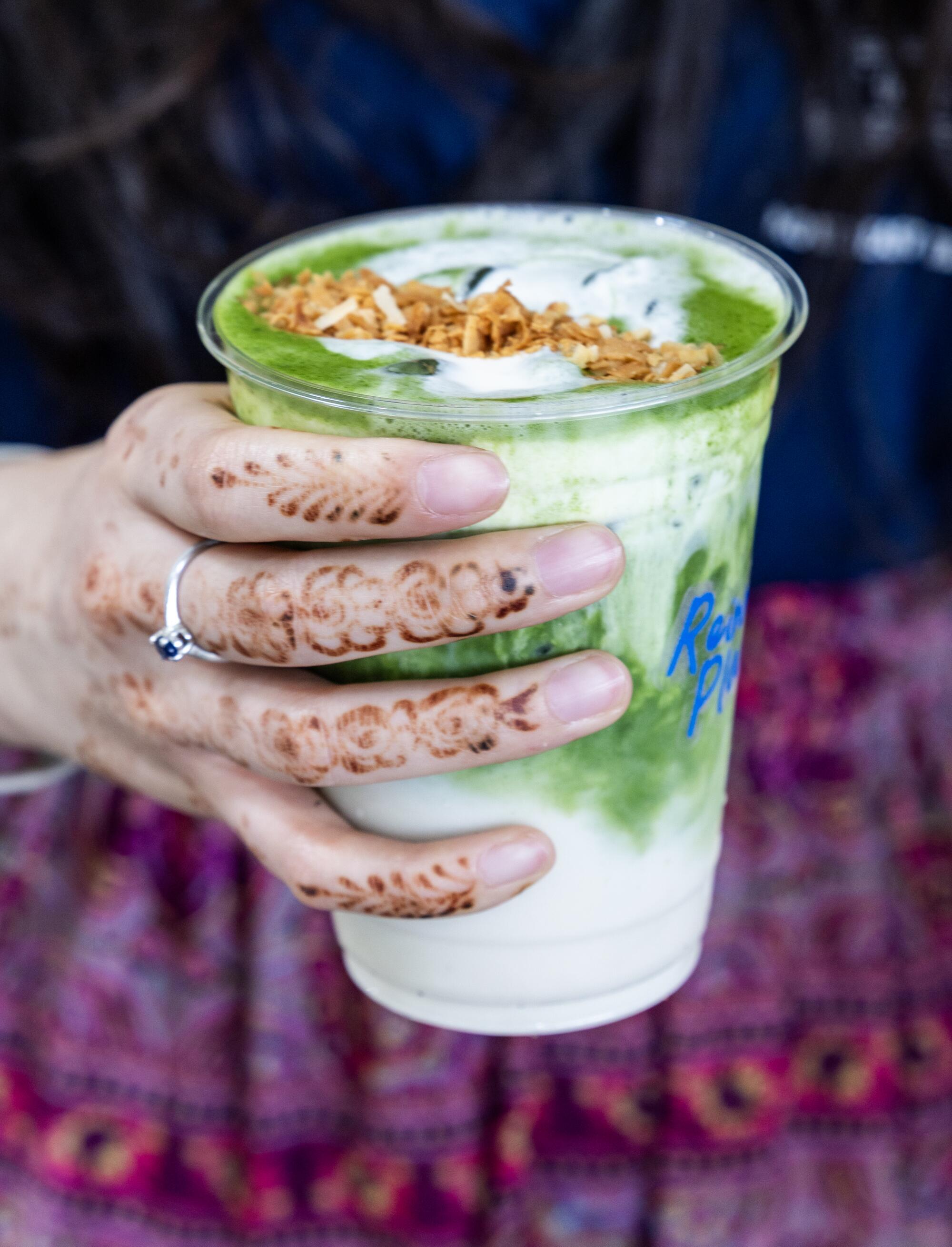 Julianne Nieh, of Vancouver, holds a matcha drink at Reinne's Place.