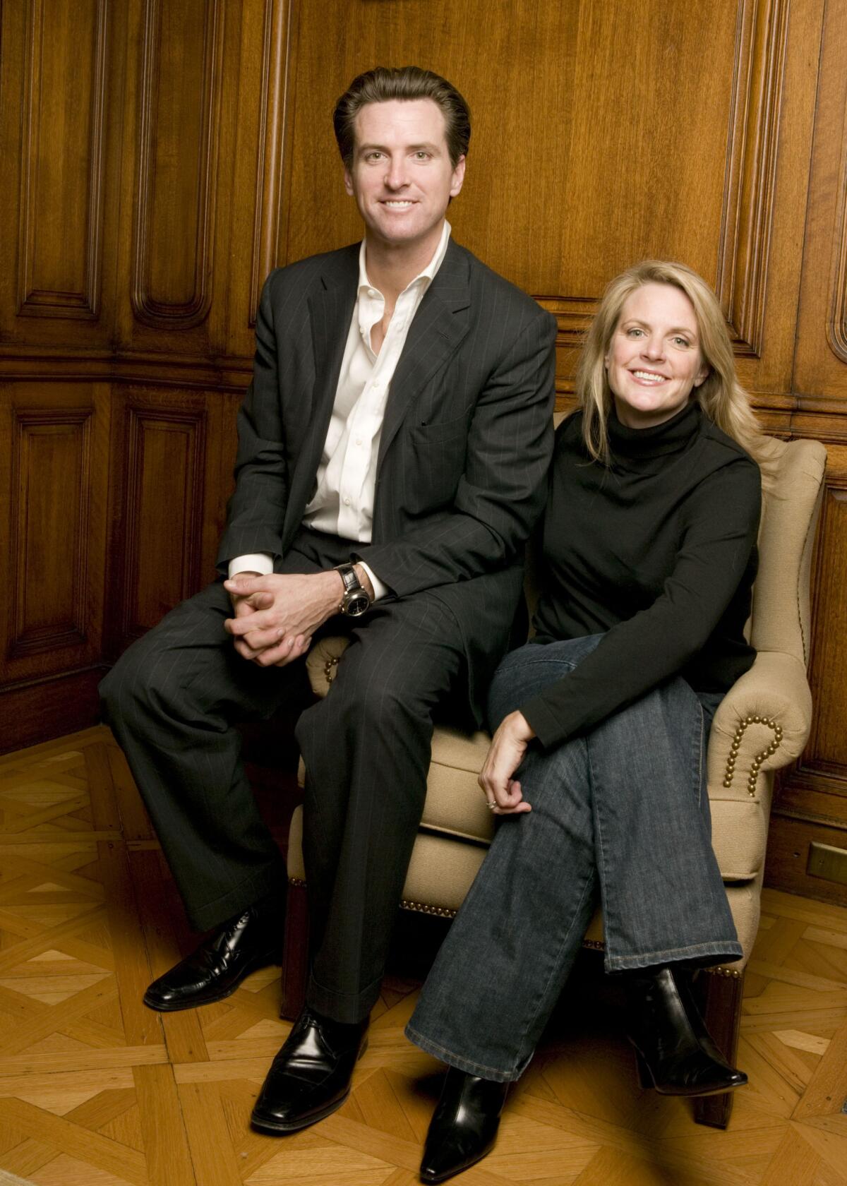 San Francisco Mayor Gavin Newsom sits on the arm of a chair that his sister, Hilary Newsom, sits in