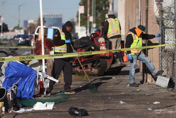 City workers remove debris from a homeless camp along East 12th Street on Tuesday, Jan. 13, 2026, in Oakland, Calif. (Aric Crabb/Bay Area News Group)