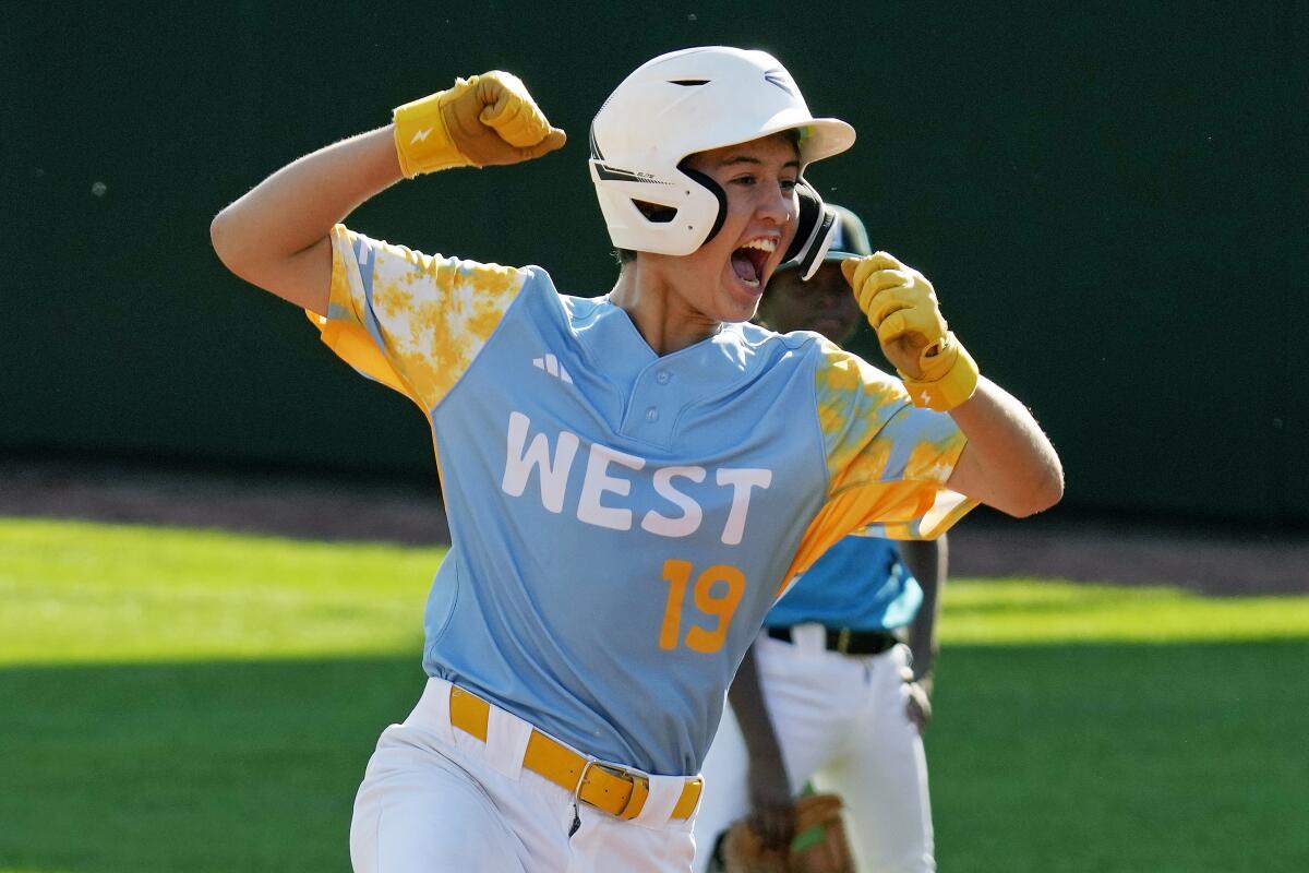 El Segundo's Louis Lappe raises his arms and shouts as he rounds second after hitting a solo walk-off home run 