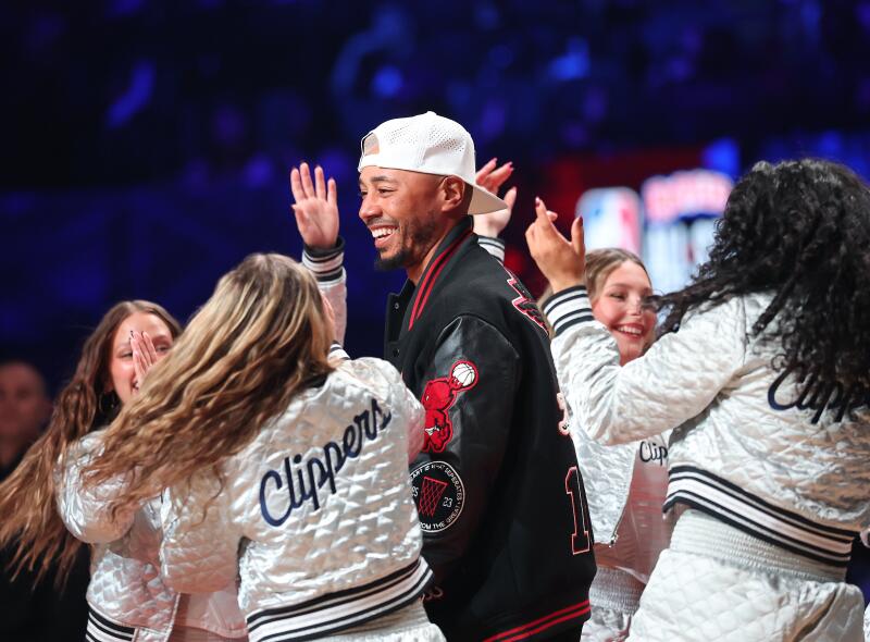 Dodgers star Mookie Betts is welcomed to the court during the celebrity all-star game by the Clippers cheerleaders.