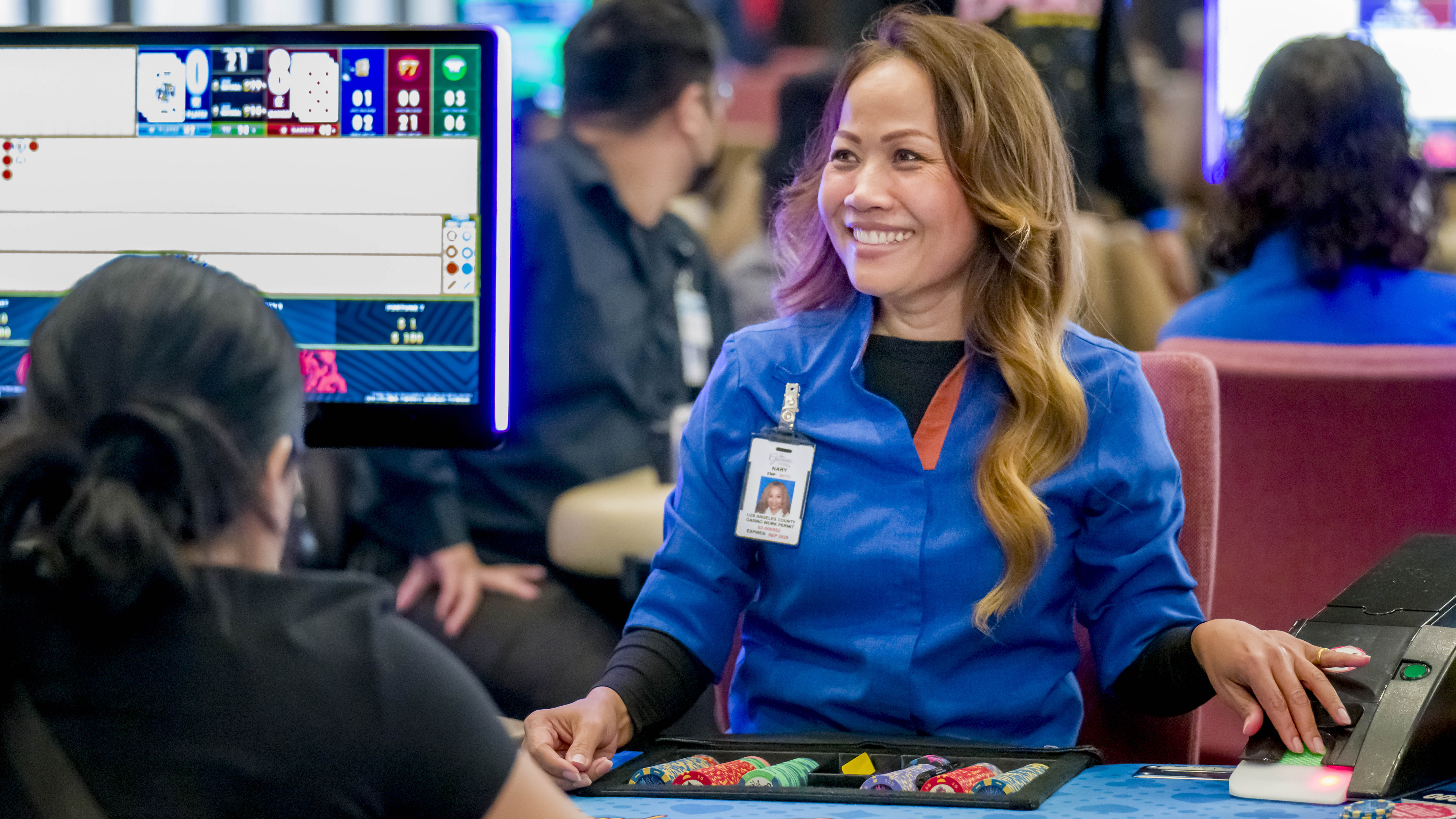 Nary Chin, center, a cardroom dealer at The Gardens Casino...