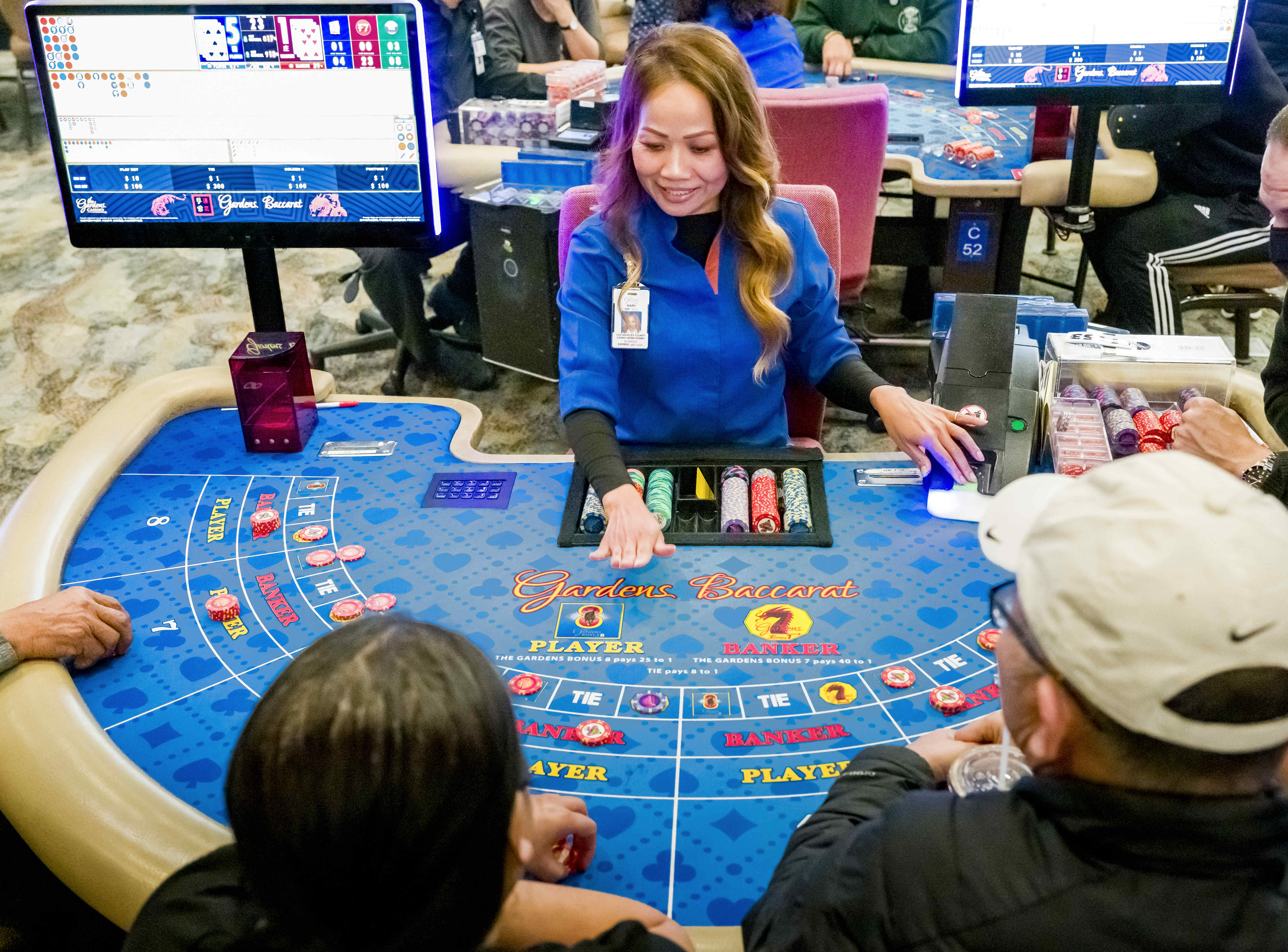 Nary Chin deals cards for a Baccarat game at The...