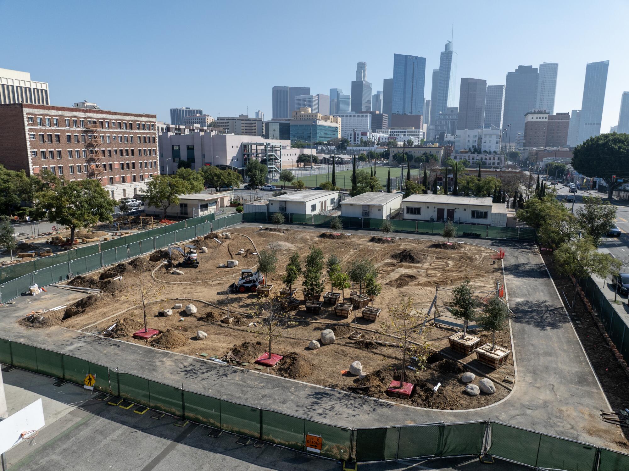Aerial view of landscaping against a backdrop of the downtown L.A. skyline
