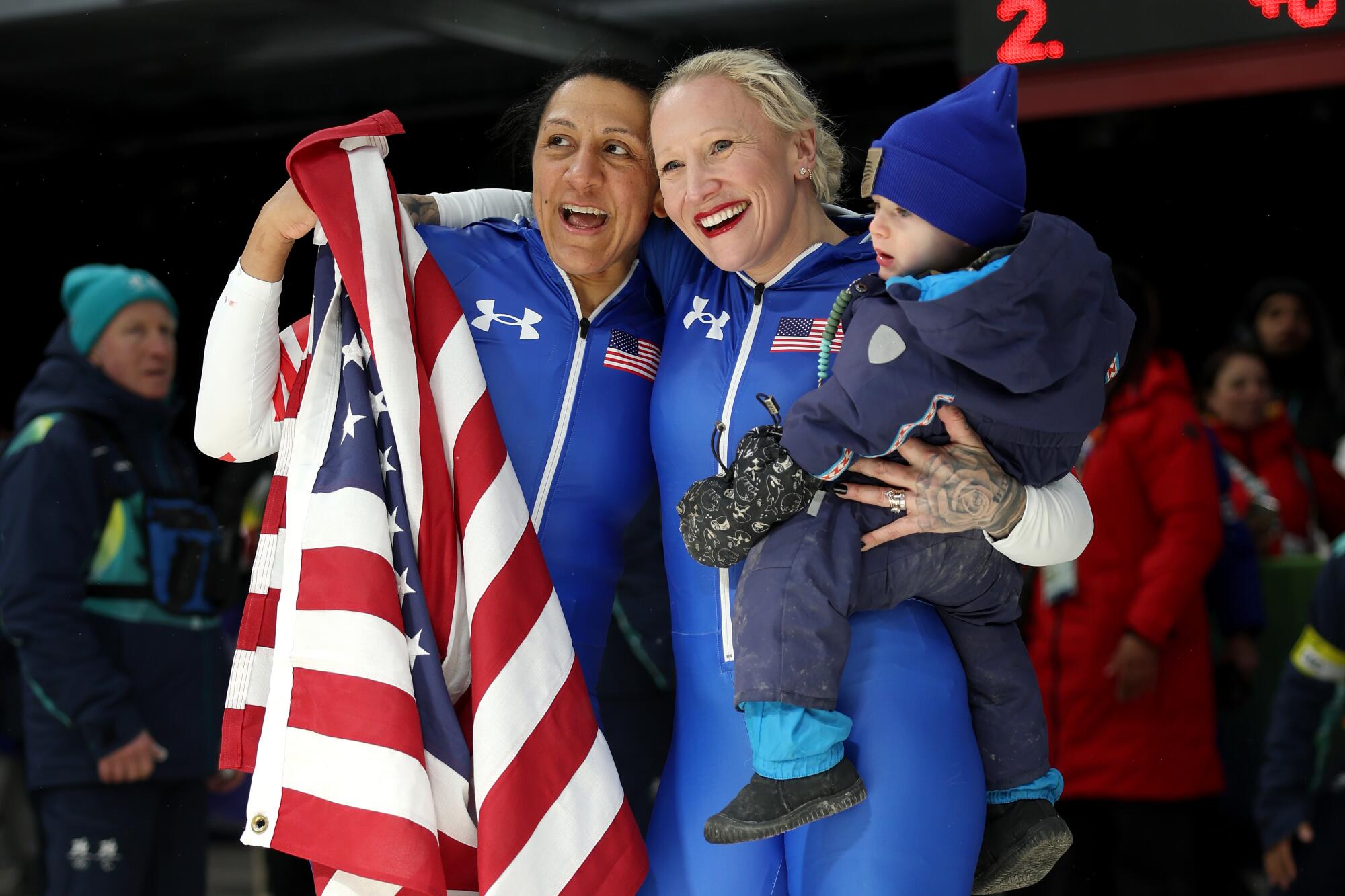 American gold medalist Elana Meyers Taylor and bronze medalist Kaillie Humphries celebrate with Humphries' son.