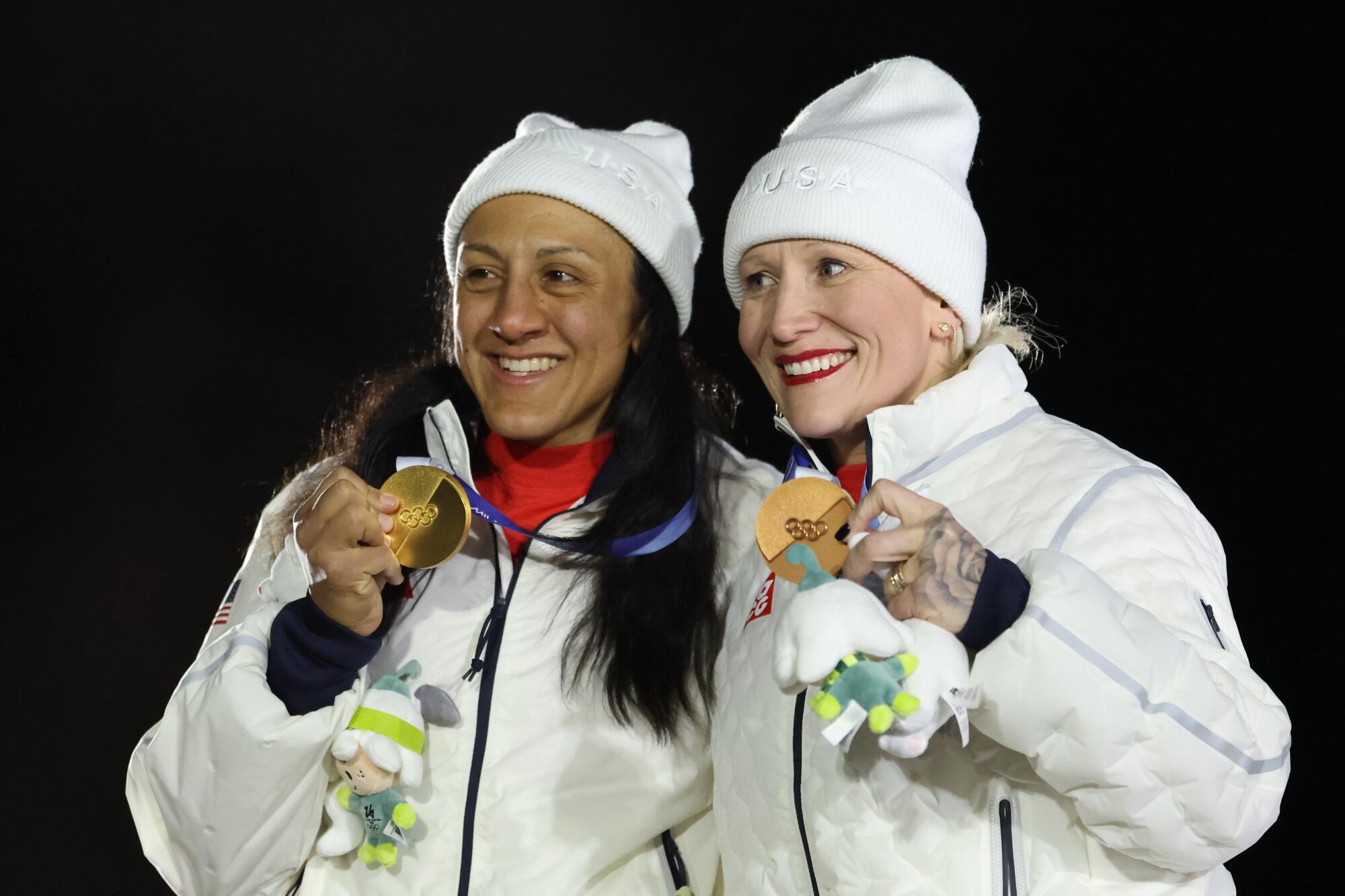 U.S. gold medalist Elana Meyers Taylor and bronze medalist Kaillie Humphries pose for a photo during the medal ceremony.