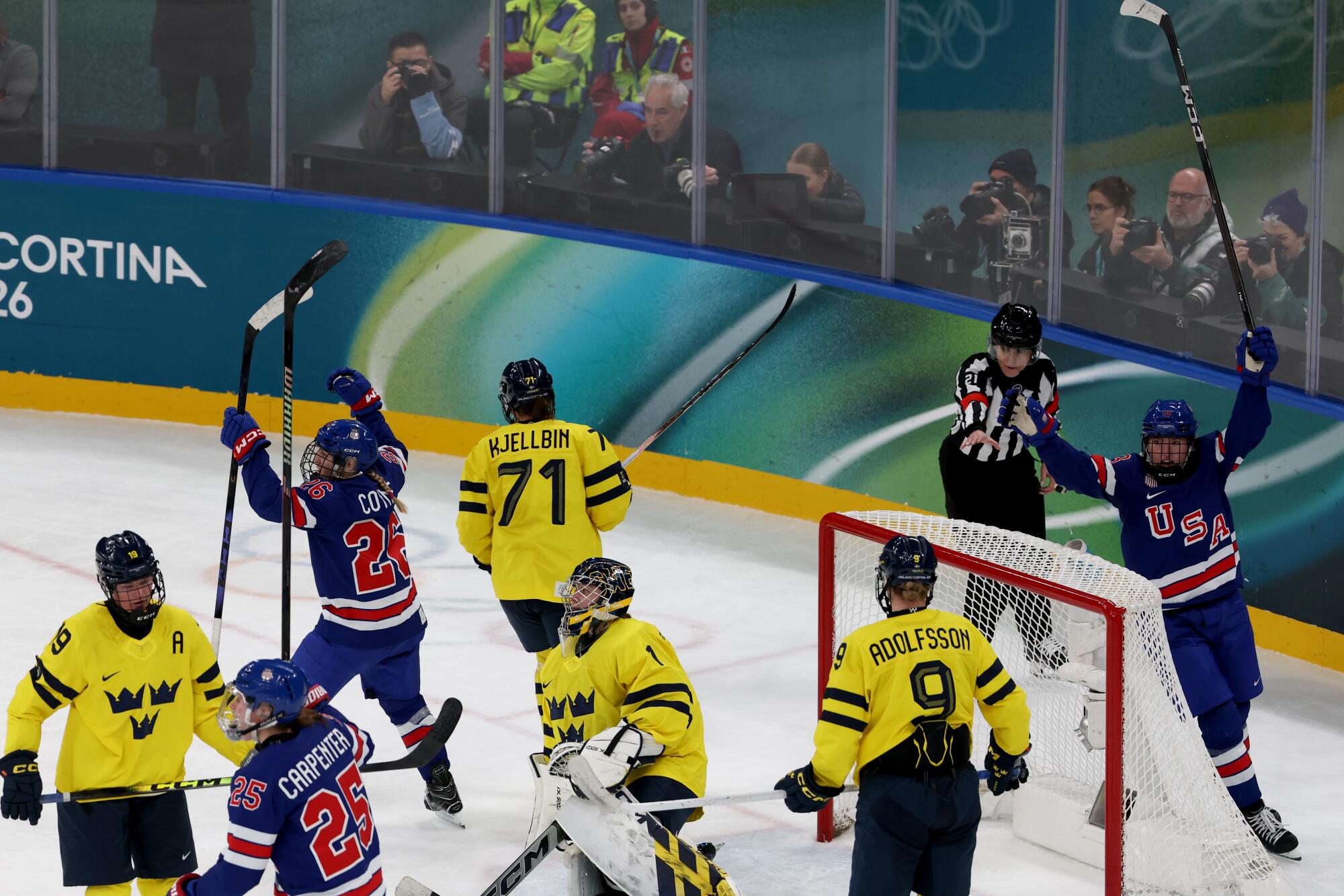 Kendall Coyne raises her stock and celebrates with her teammates after scoring against Sweden.