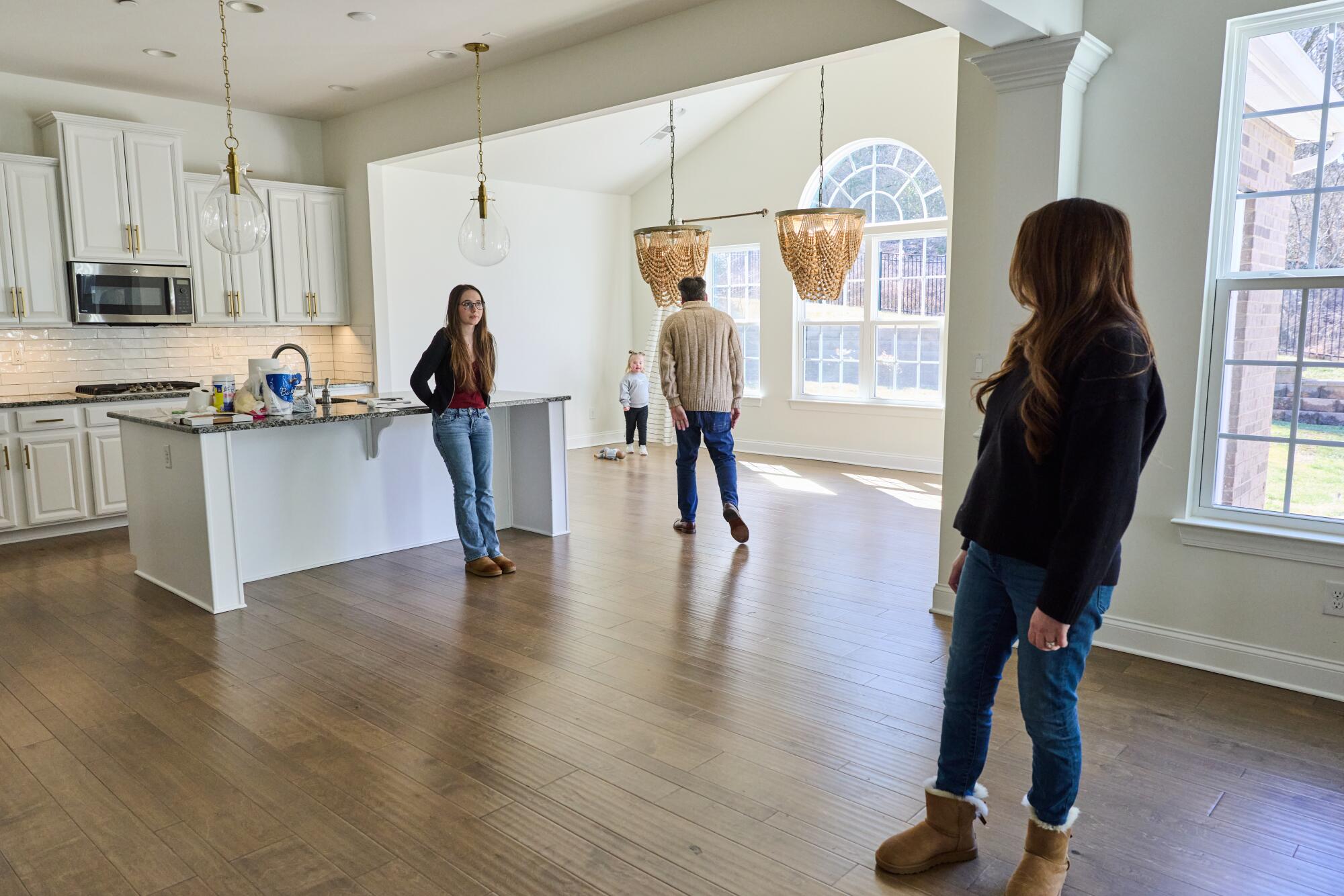 The McIntire family inside an empty home