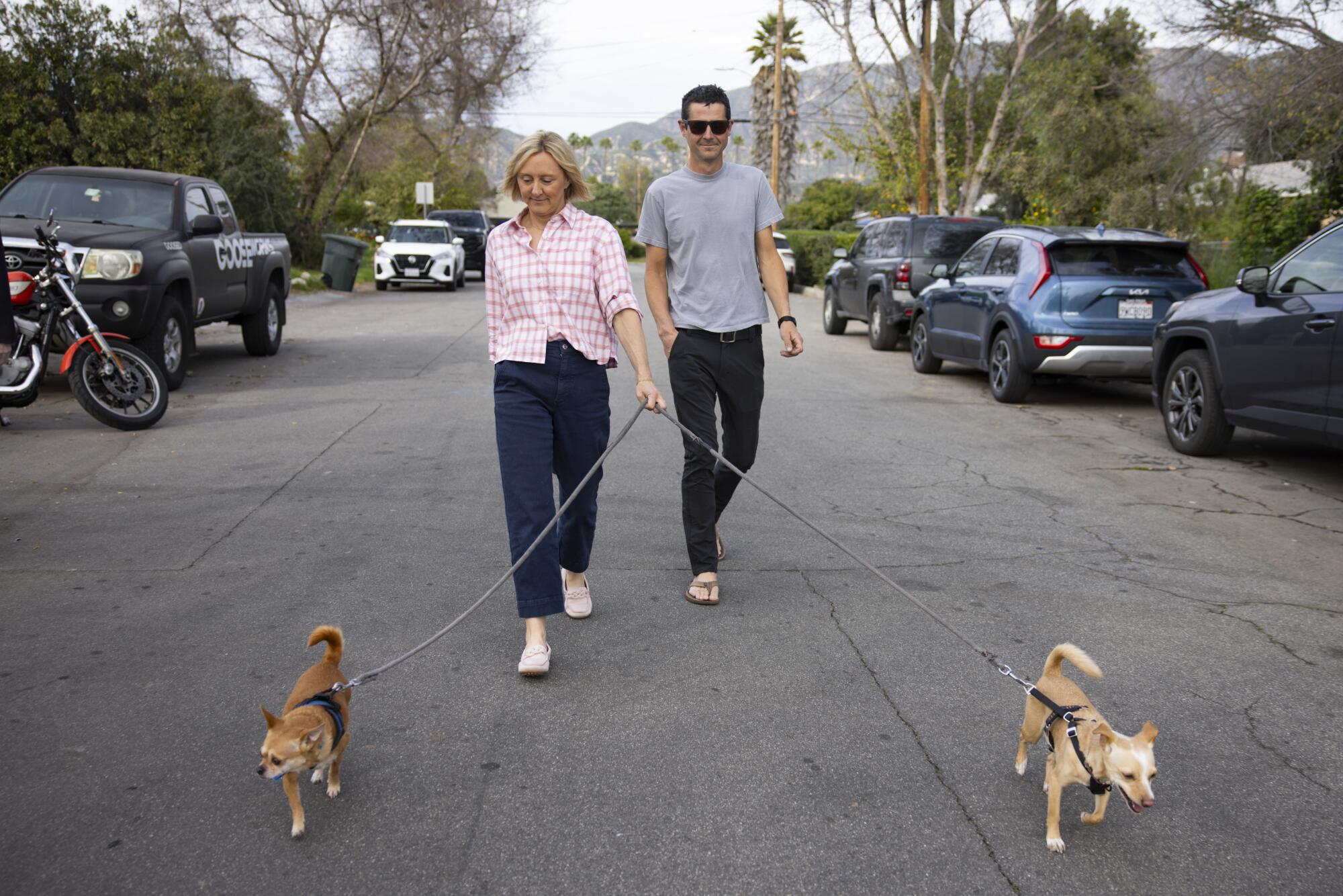 Nicole and Mike Wirth with two dogs on leashes