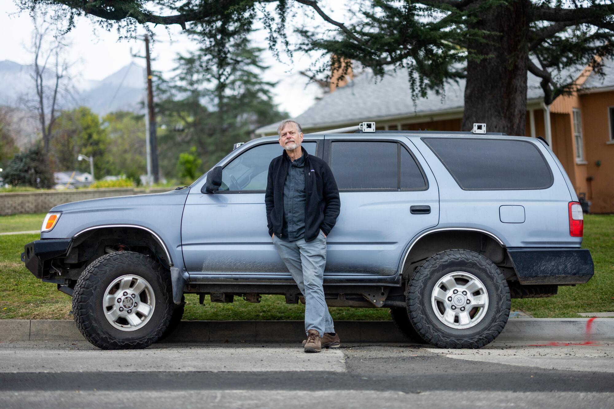 Altadena resident Robert Steller stands in front of his parked Toyota 4runner