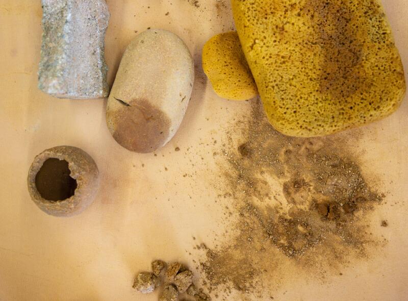 Sculptures showing lion faces and feet as well as ceramics tools.