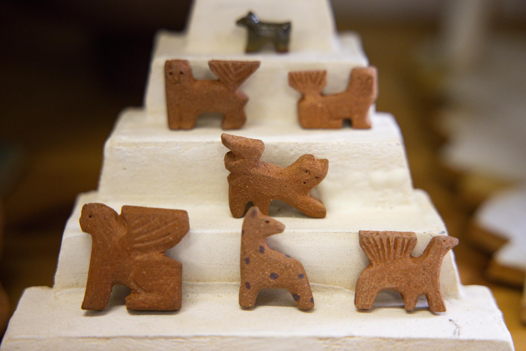 Small ceramic figurines in the shape of fantastical animals. 