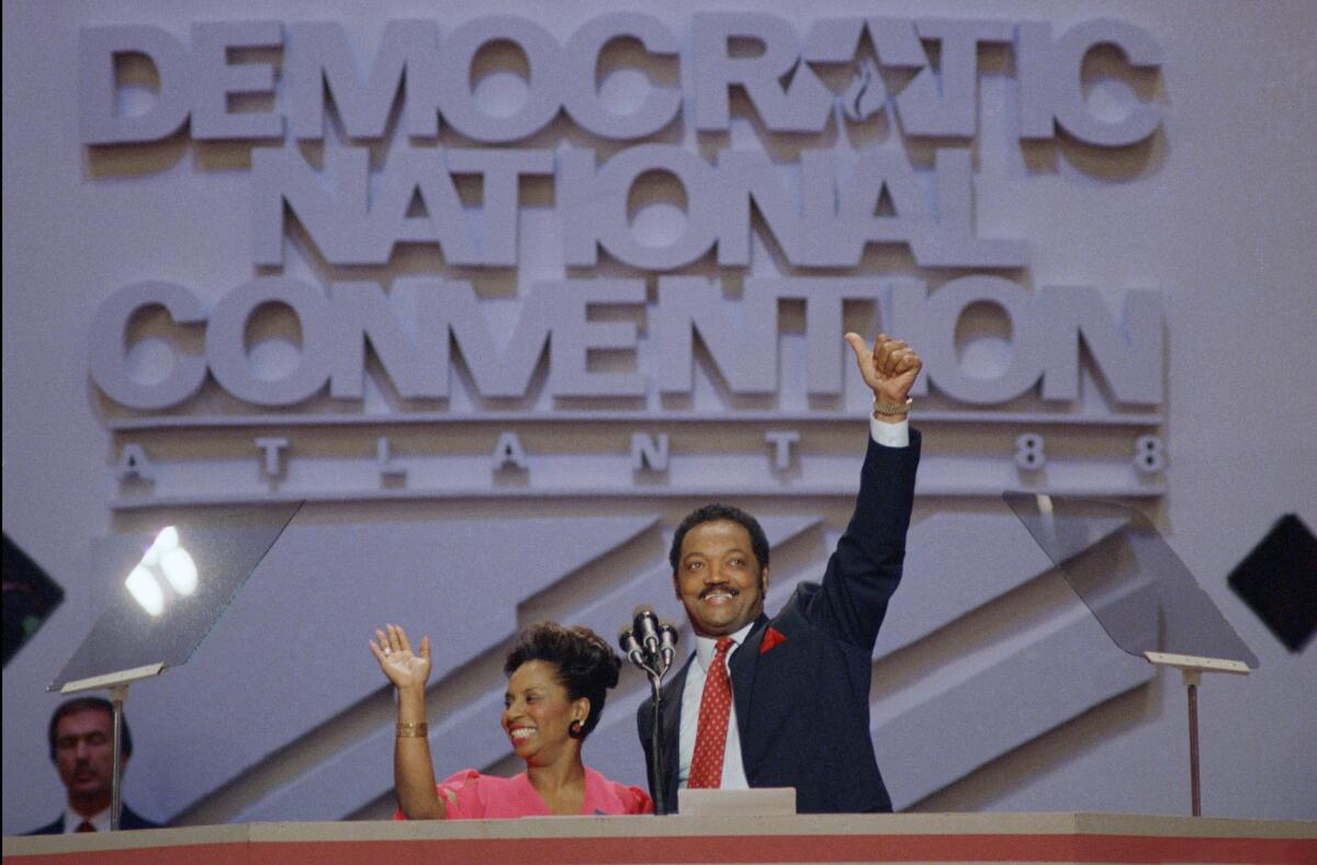 Rev. Jesse Jackson and his wife, Jacqueline, acknowledge the cheers of delegates and supporters