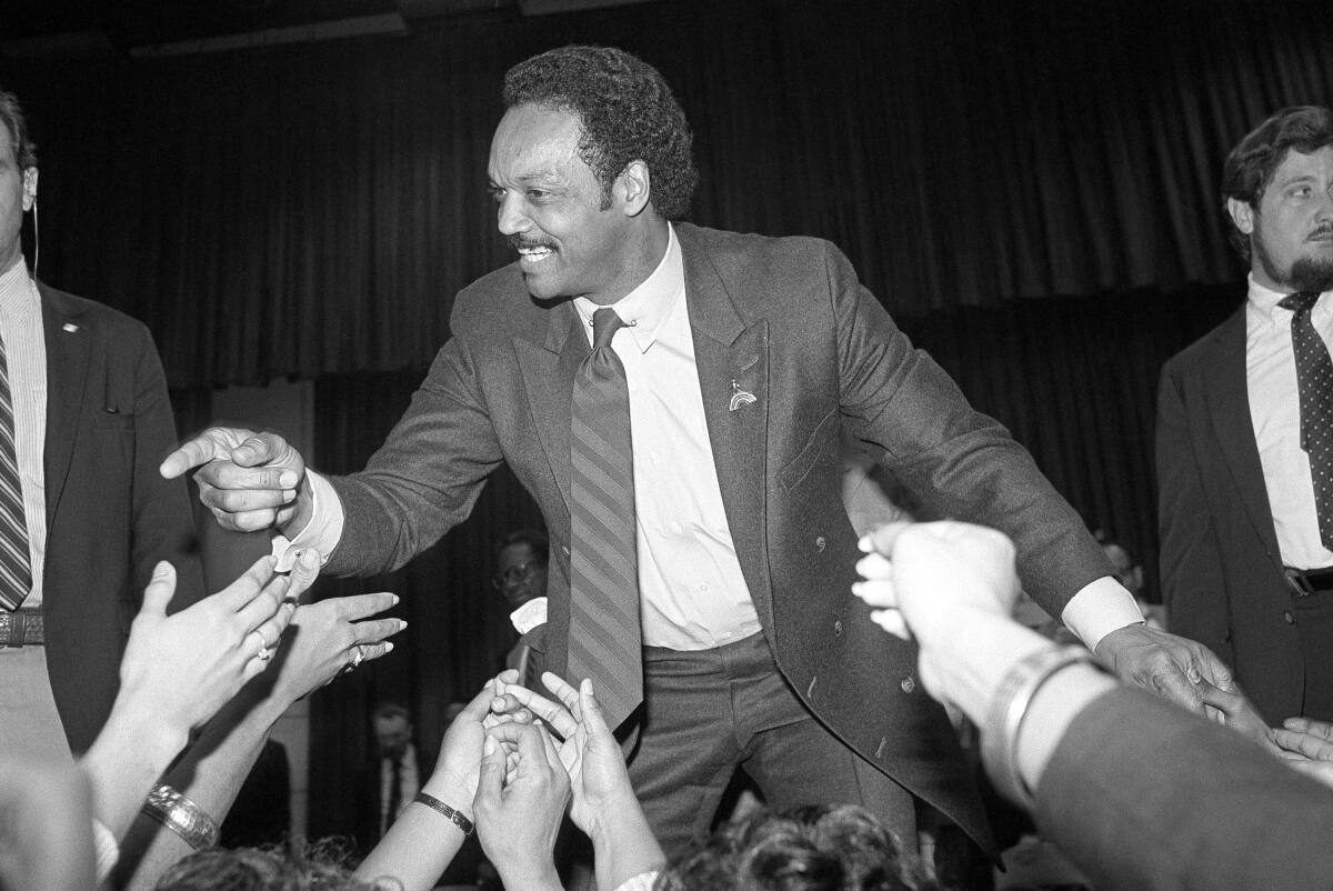 The Rev. Jesse Jackson works the crowd from onstage following a speech at the Cincinnati Convention center.