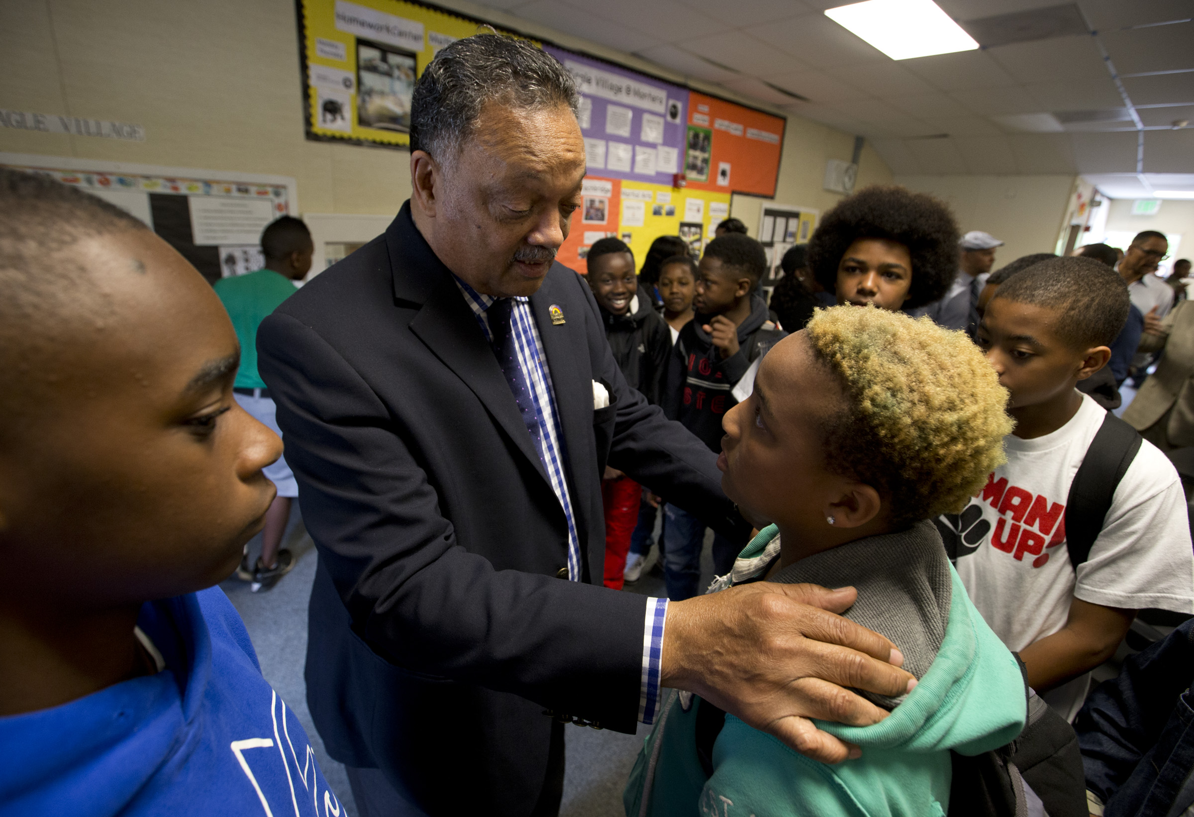 Rev. Jesse Jackson, second from left, speaks to 13-year-old 8th...
