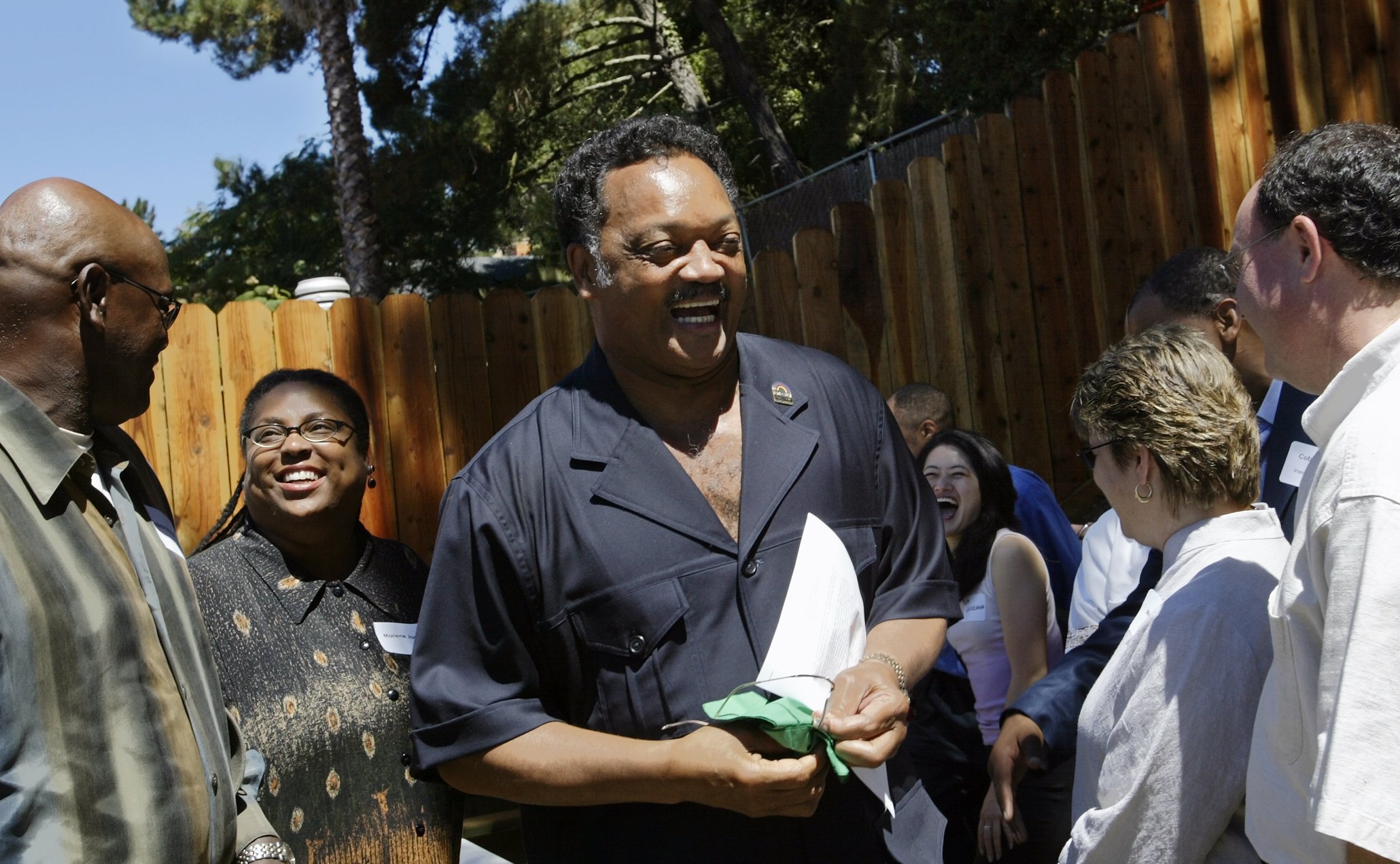 Rev. Jesse Jackson is greeted by supporters and friends as...