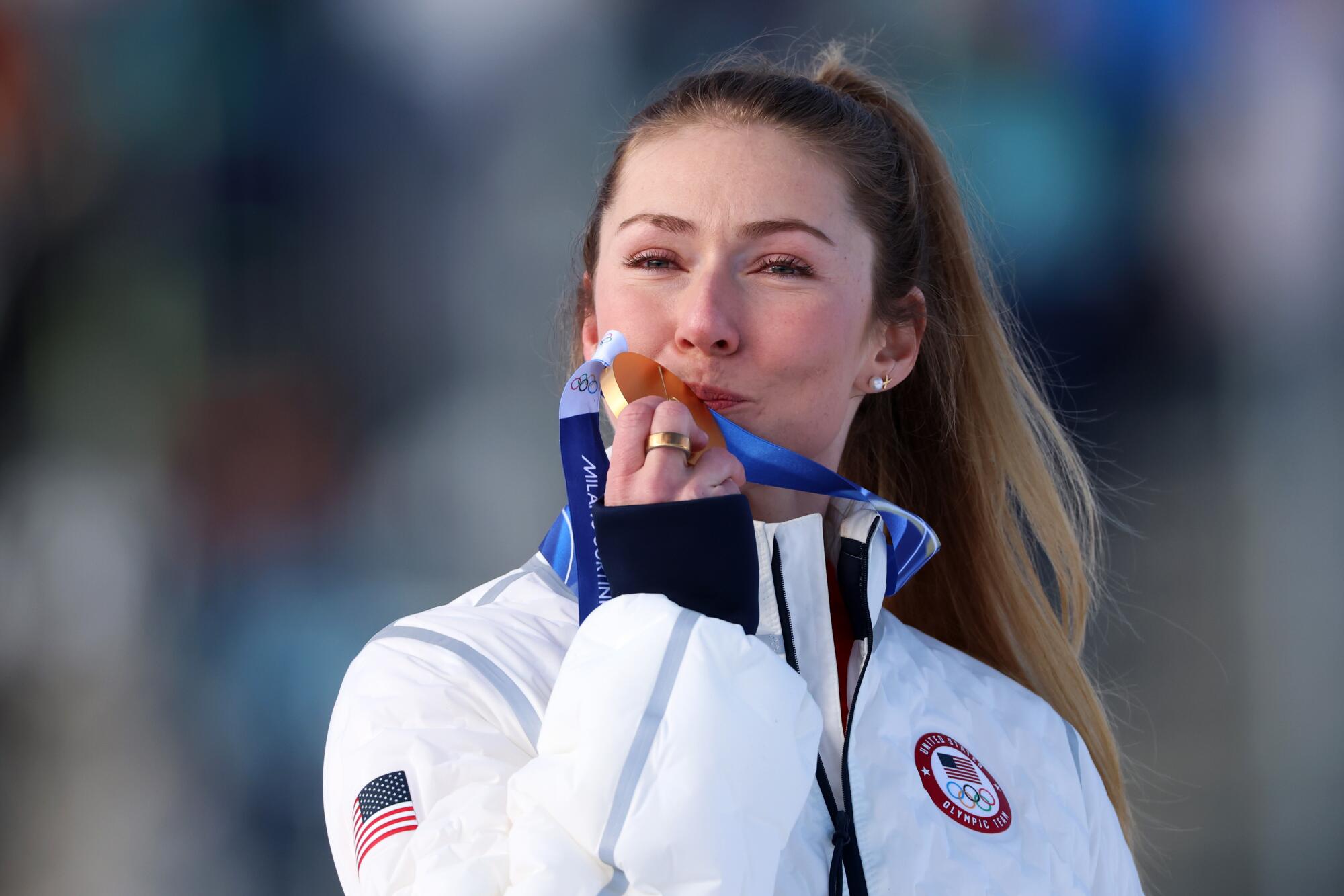 Gold medalist Mikaela Shiffrin celebrates on the podium during the medal ceremony following the Women's Slalom race.