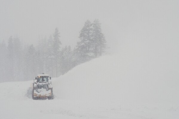 A road is cleared during a snow storm on Wednesday, Feb. 18, 2026 near Soda Springs, Calif. (AP Photo/Brooke Hess-Homeier)