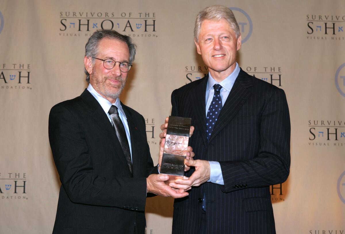 Director Steven Spielberg presents former president Bill Clinton with the Ambassadors Humanity award 