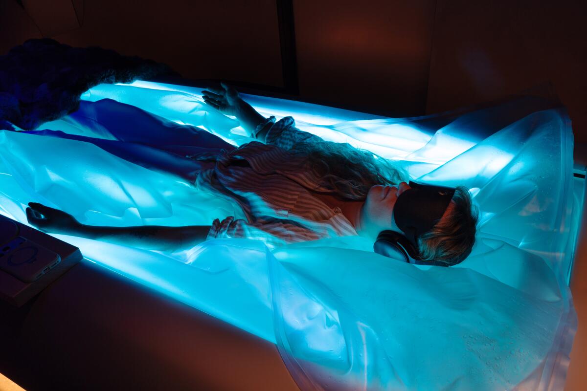 A person floats in a float tank 
