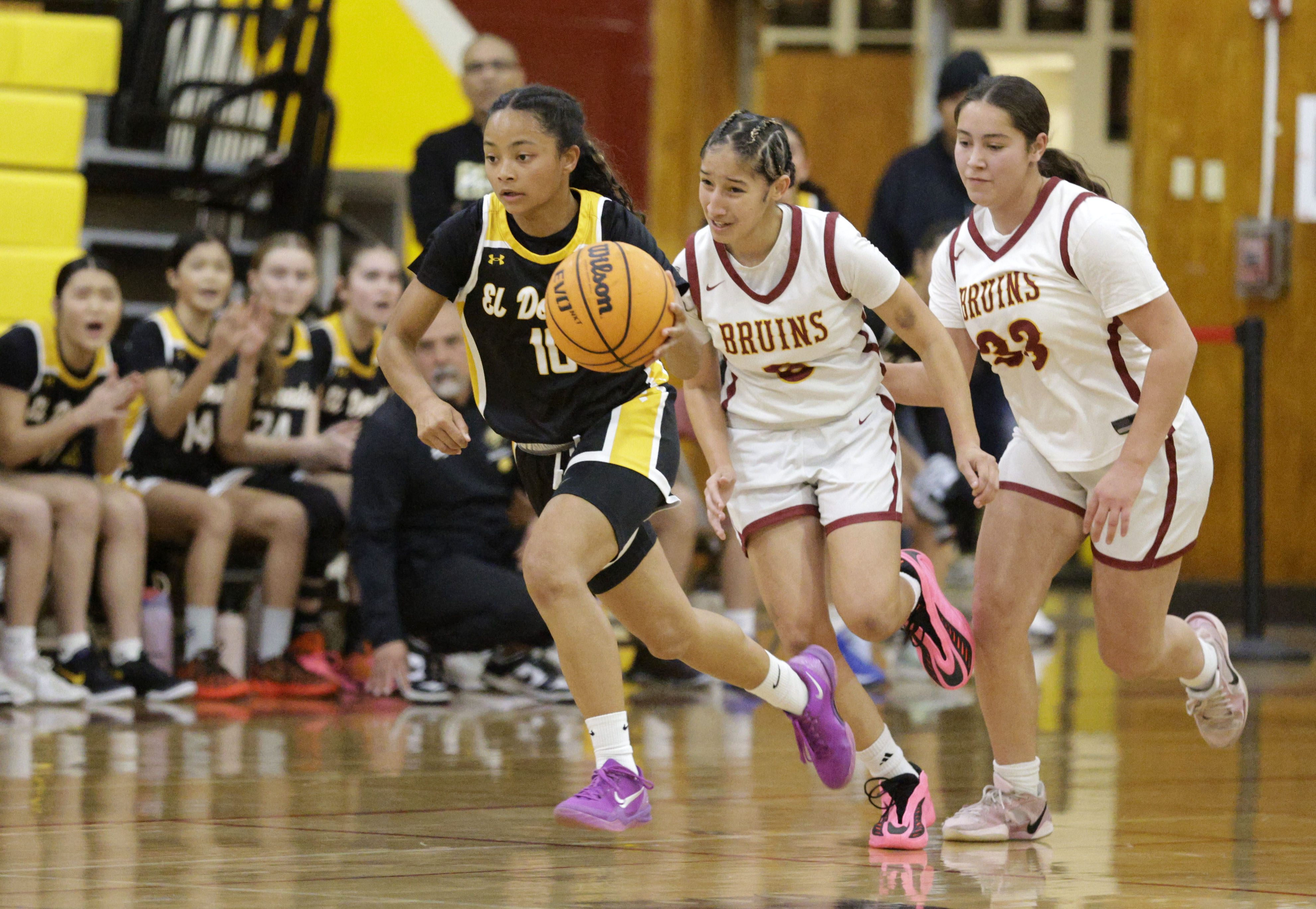 El Dorado’s Kennedy Wood (10) races ahead of Wilson’s Emily...