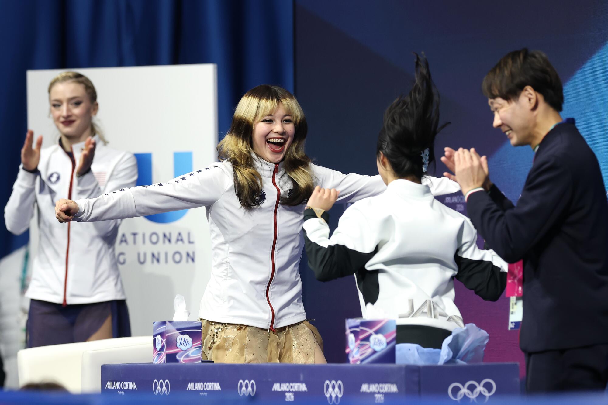 American gold medalist Alysa Liu hugs Japanese bronze medalist Ami Nakai after their final scores were revealed.