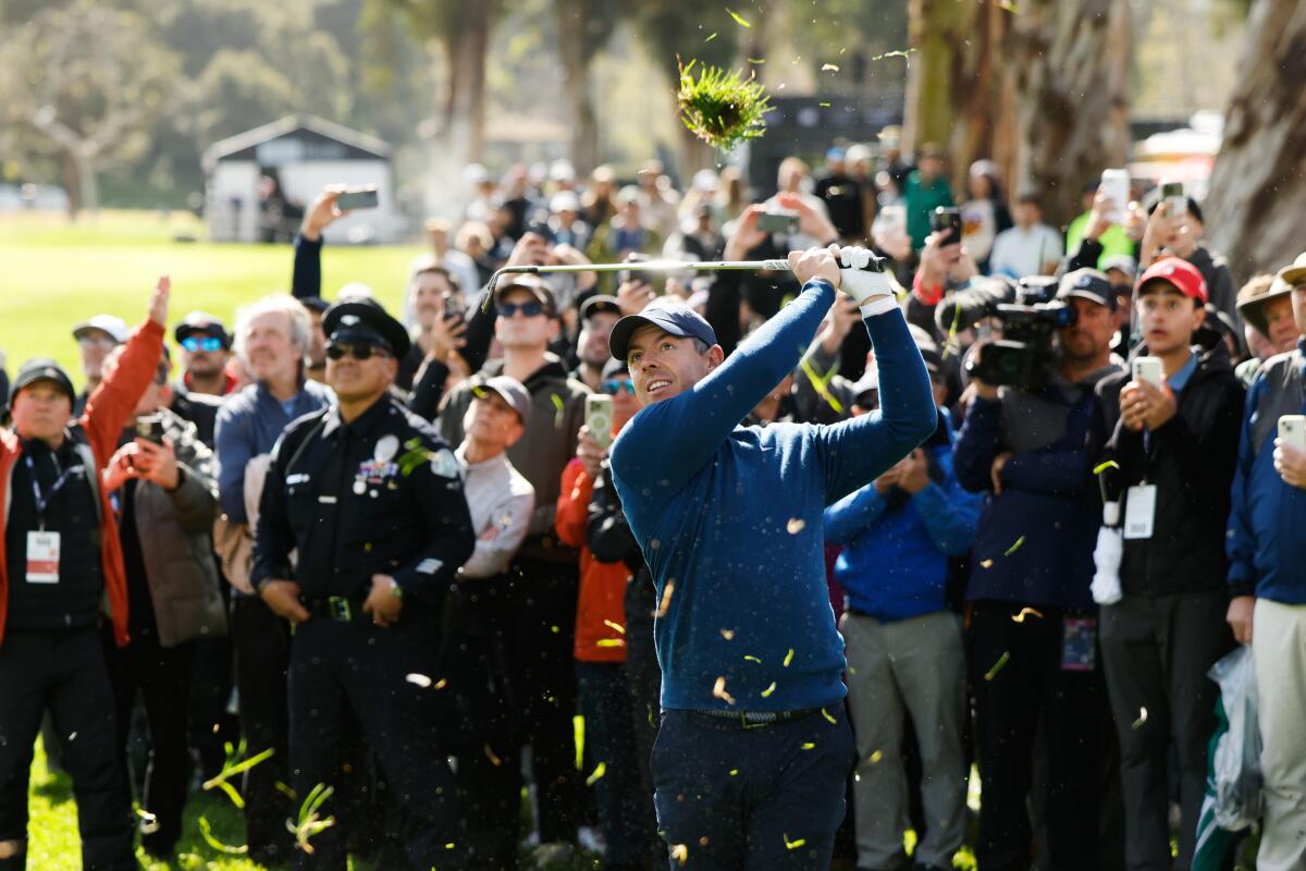 Rory McIlroy hits from a fairway rough on the eighth hole during the first round of the Genesis Invitational.