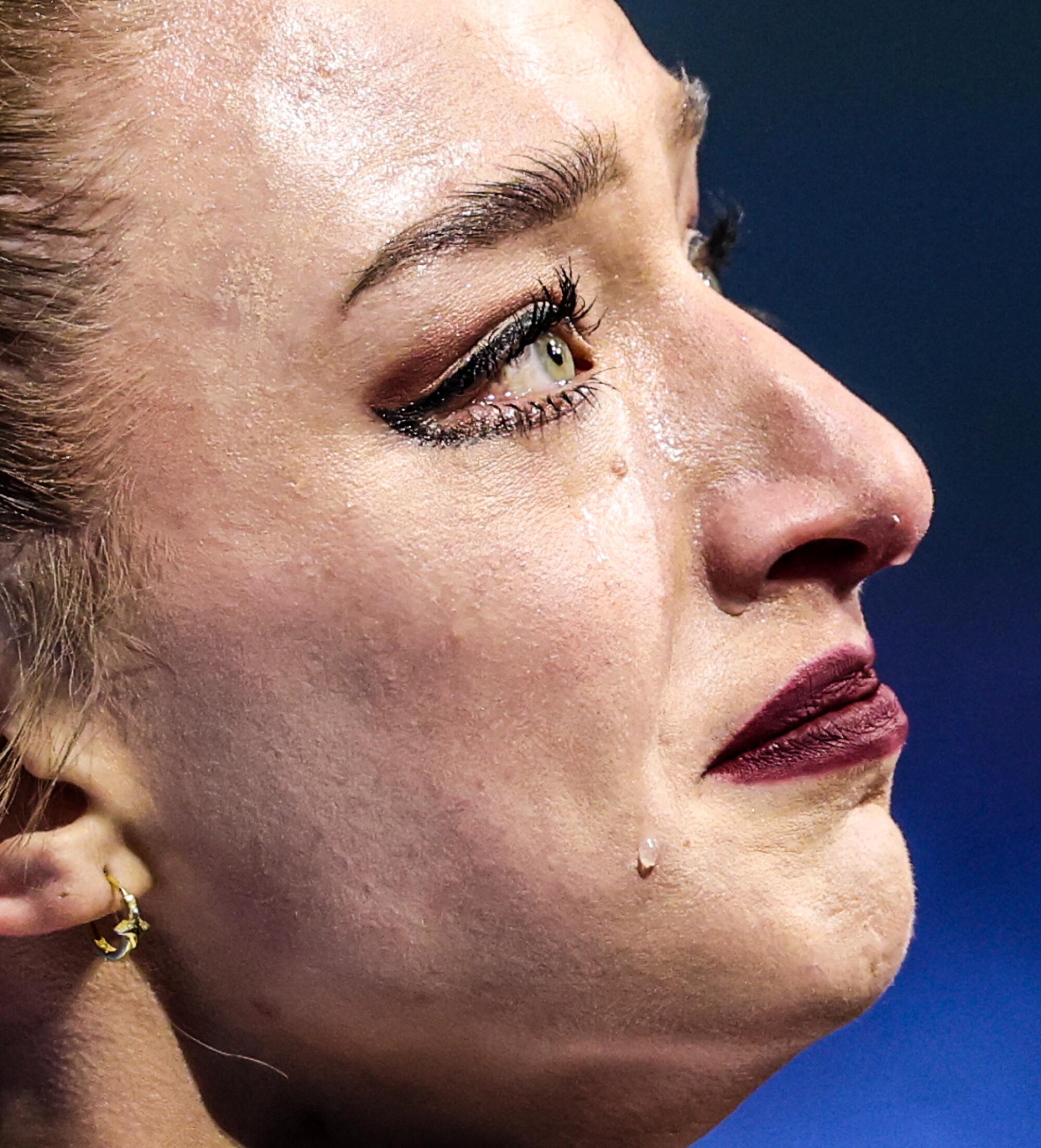 USA skater Amber Glenn weeps after completing an imperfect routine in the single skating short program.