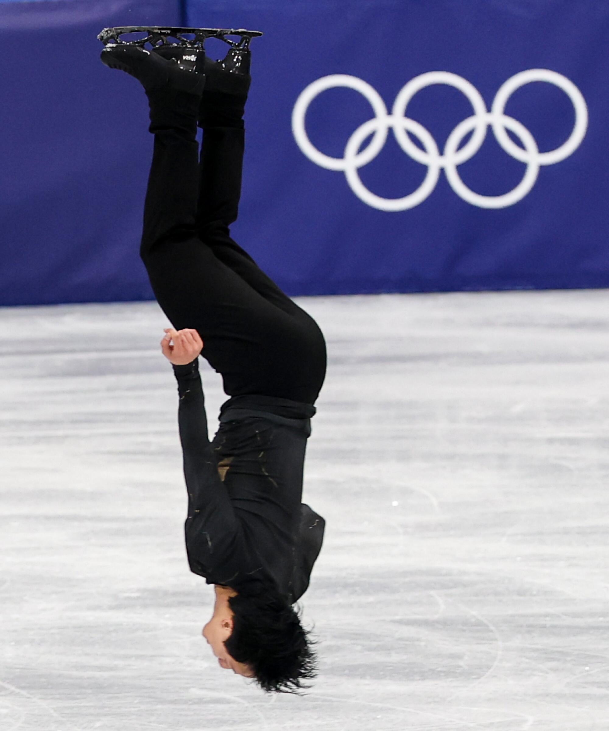 French skater Adam Siao Him Fa performs a flip during the finals for Men's Single Skating.