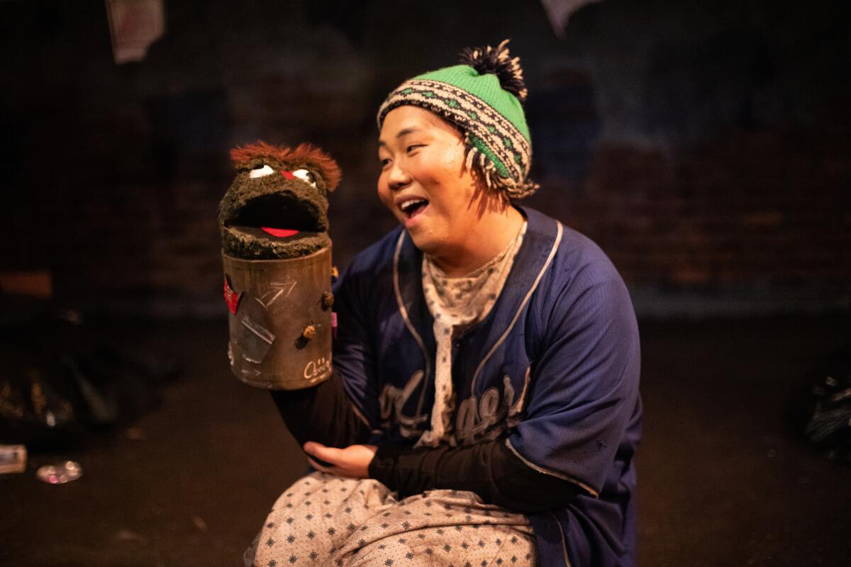 An actor interacts with a puppet during Breath of Fire's production of “Sometimes, I Wish."