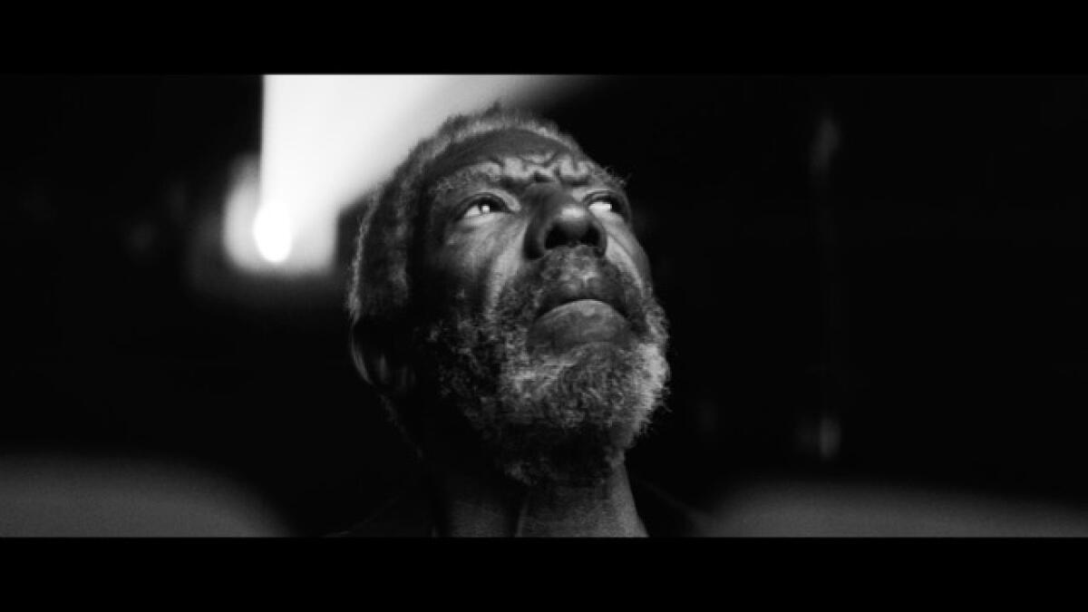 A man looks upward, dolefully.