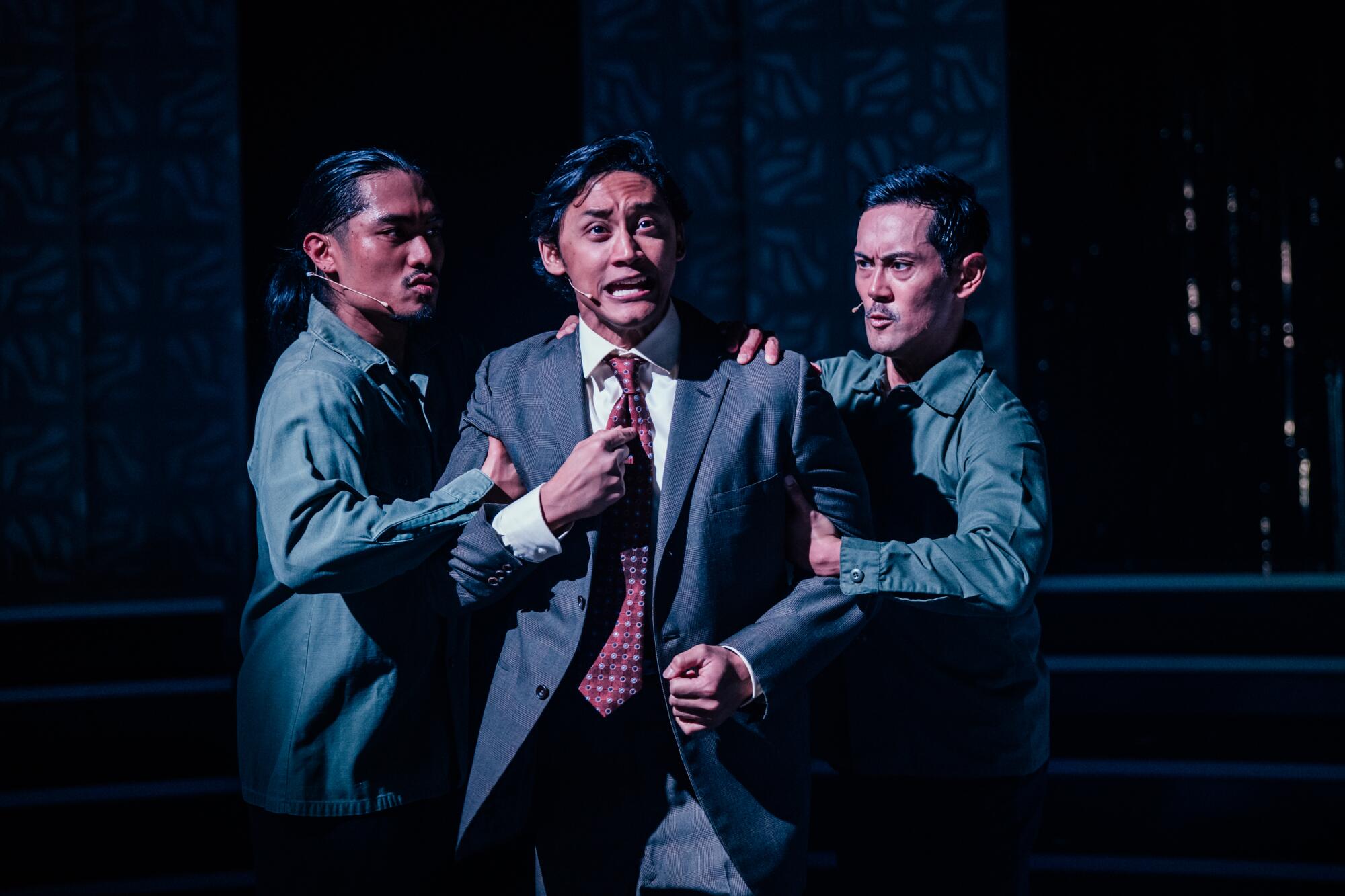 Jeff Lorenz Garrido, from left, Joshua Dela Cruz, and Garrick Goce Macatangay in "Here Lies Love" at the Mark Taper Forum.