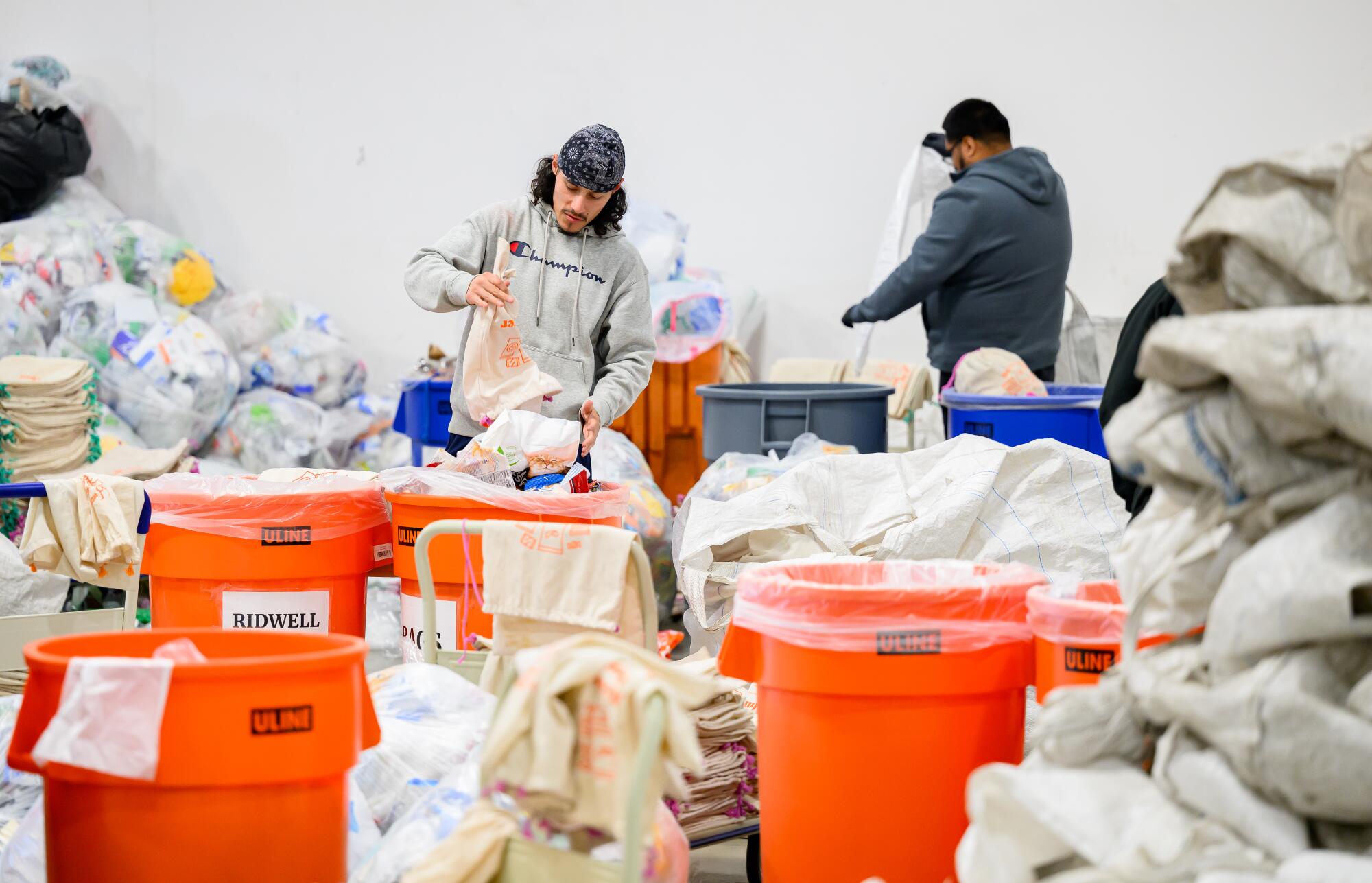 Workers sift through recyclables