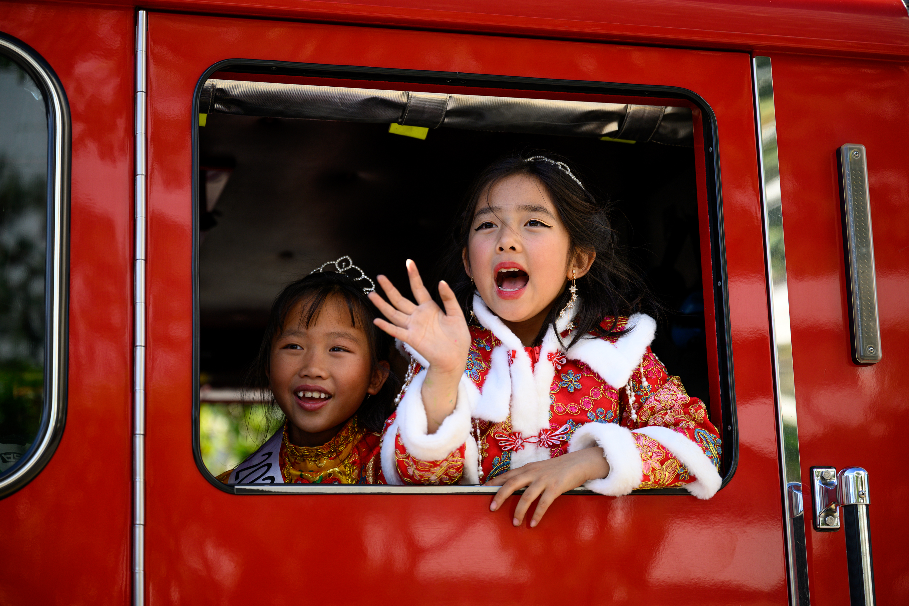 Los Angeles Chinatown Royalty wave out the window of a...