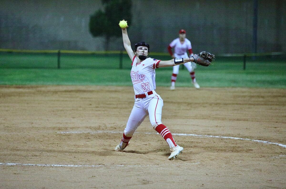 Fullerton pitcher Analise Barrios strides forward as she unleashes a windmill pitch.