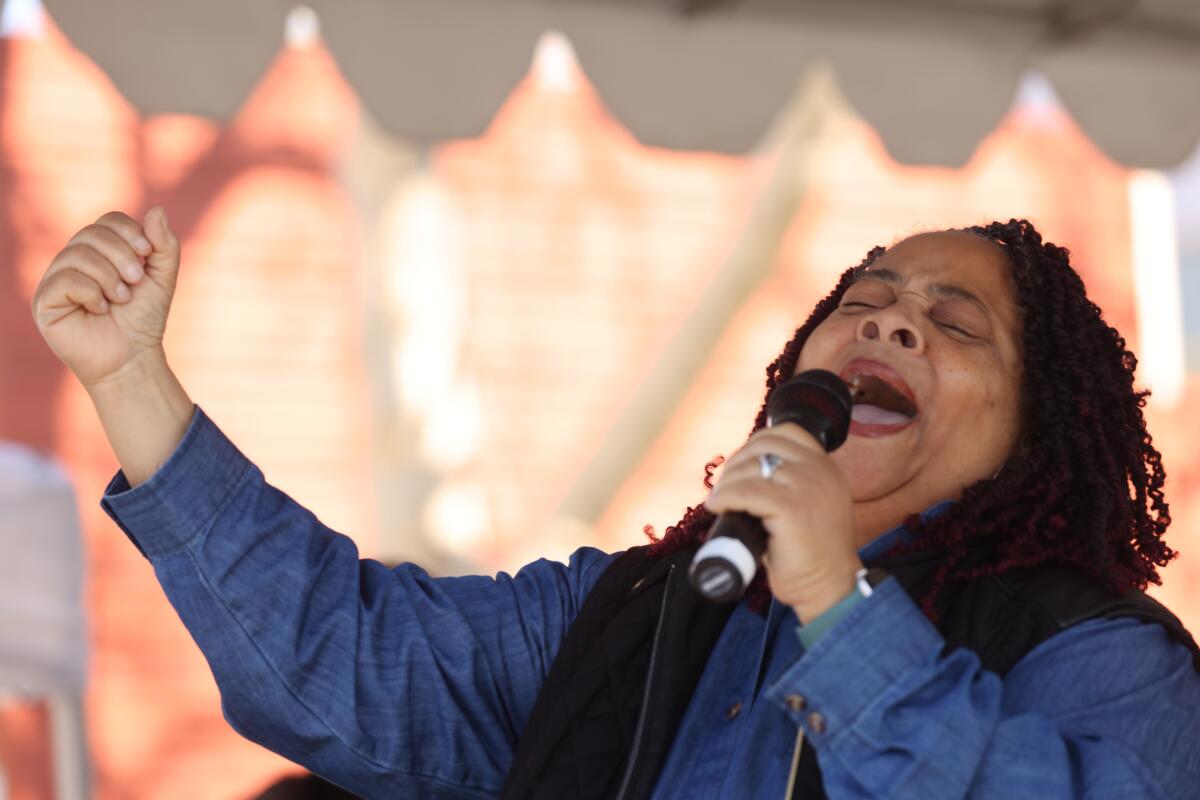 a woman singing into a microphone