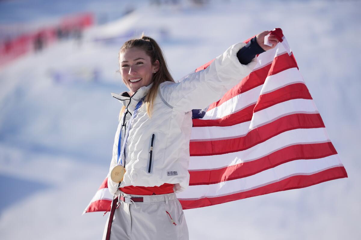 United States' Mikaela Shiffrin celebrates winning the gold medal in an alpine ski.
