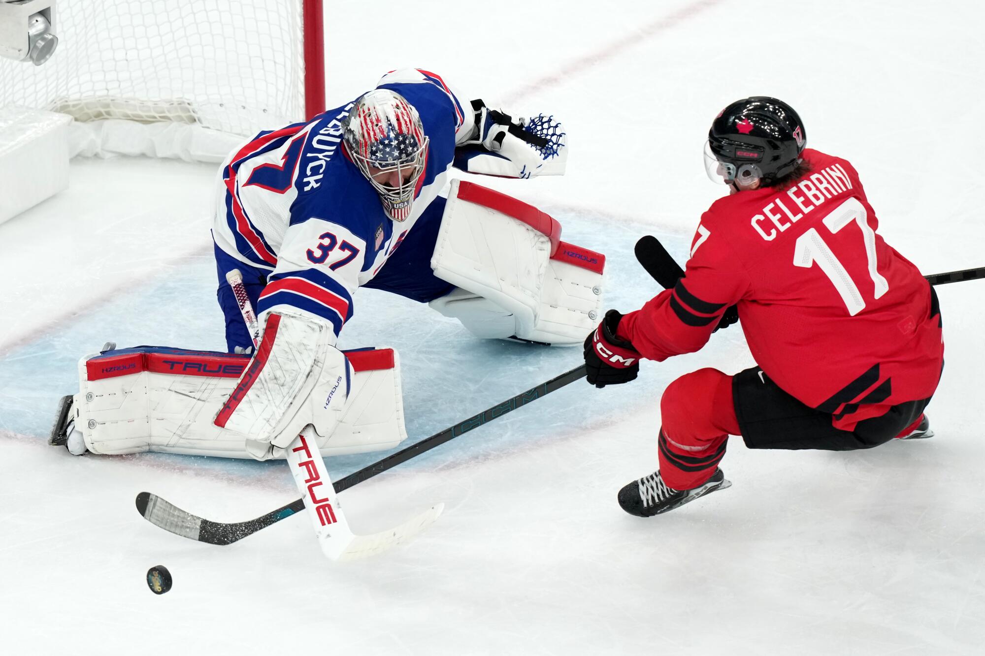 U.S. goaltender Connor Hellebuyck blocks a shot by Canada's Macklin Celebrini during the third period Sunday.