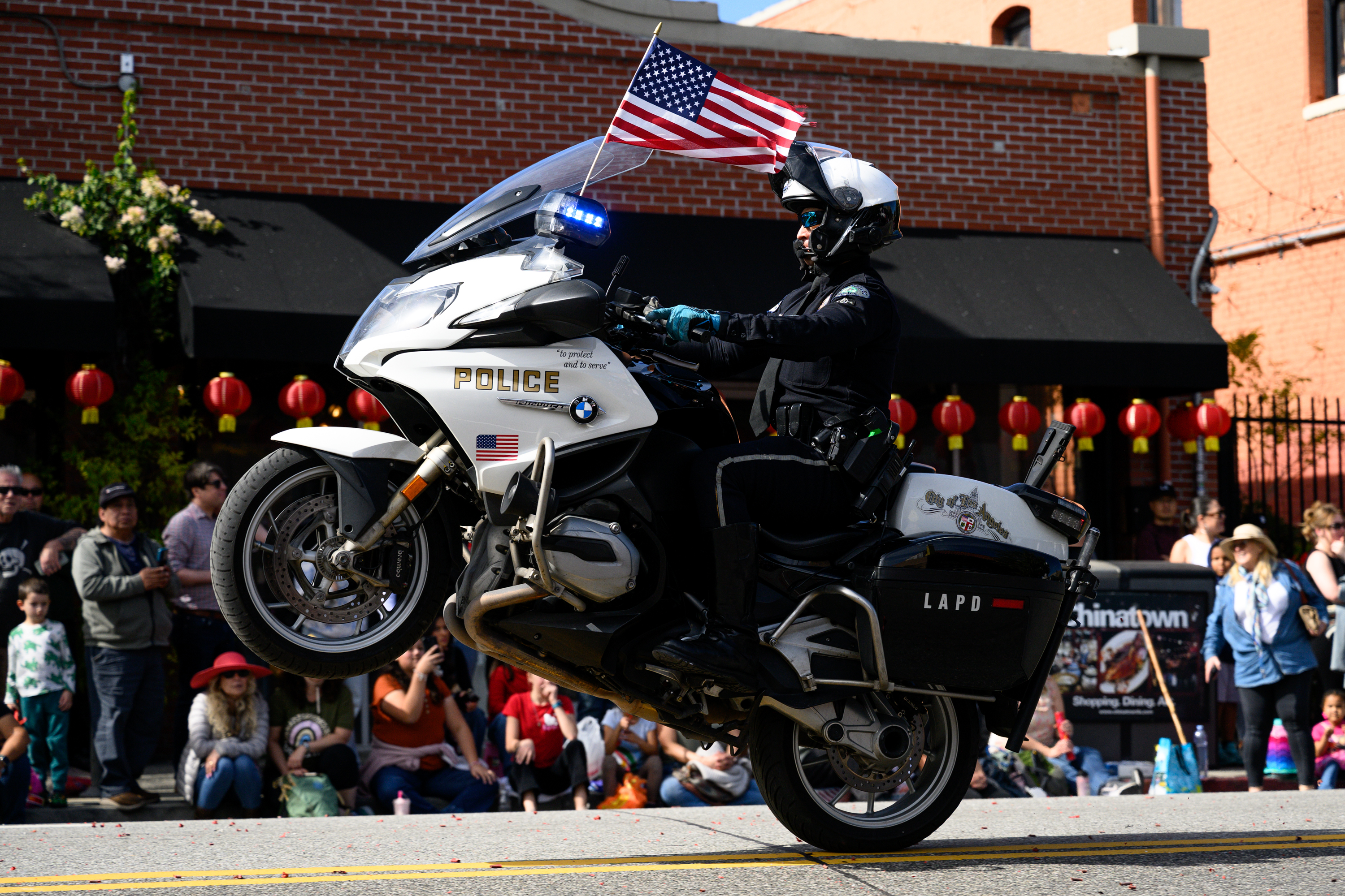A Los Angeles police officer does a wheelstand during the...