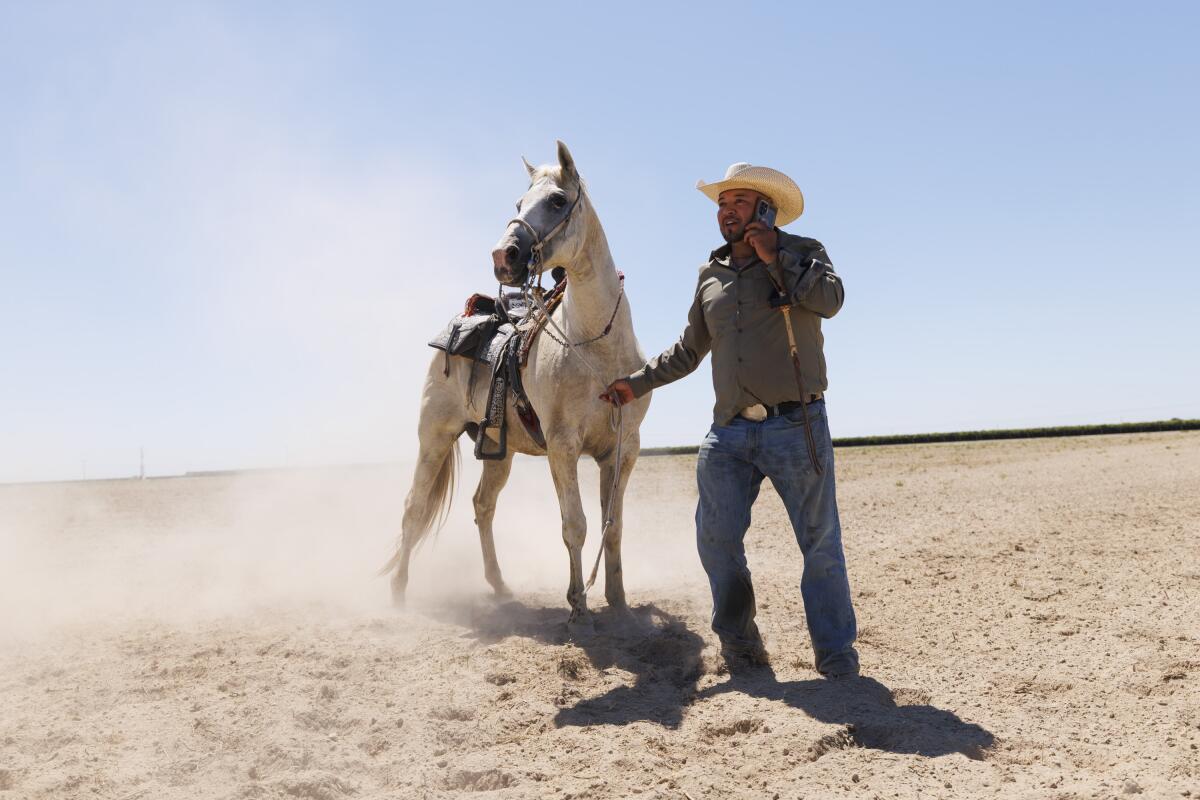 Emilio Carranza Sr. calls for a backup saddle when a stirrup breaks.