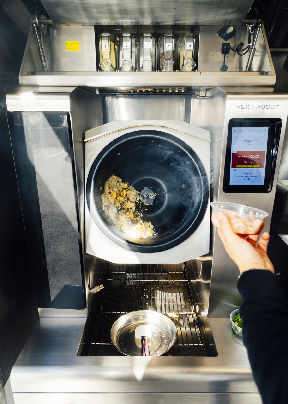 Robby, a robot wok made by Next Robot. 