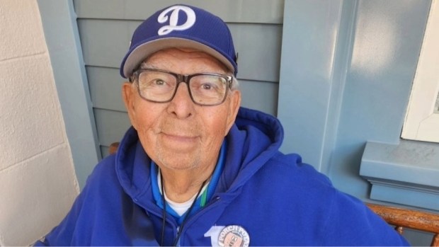 Porch Potato Frank Rodriguez sits on the Fargo's Palm Parlor porch bench along Main Street U.S.A. at Disneyland. (Orange County Register obituaries)